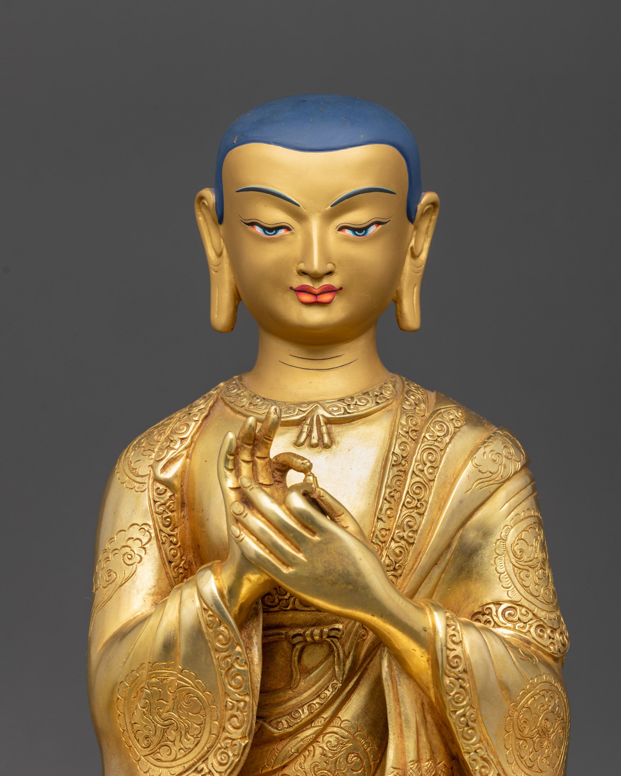 Close up Lama Atisa face with serene divine expression, gold-gilded and detailed carvings