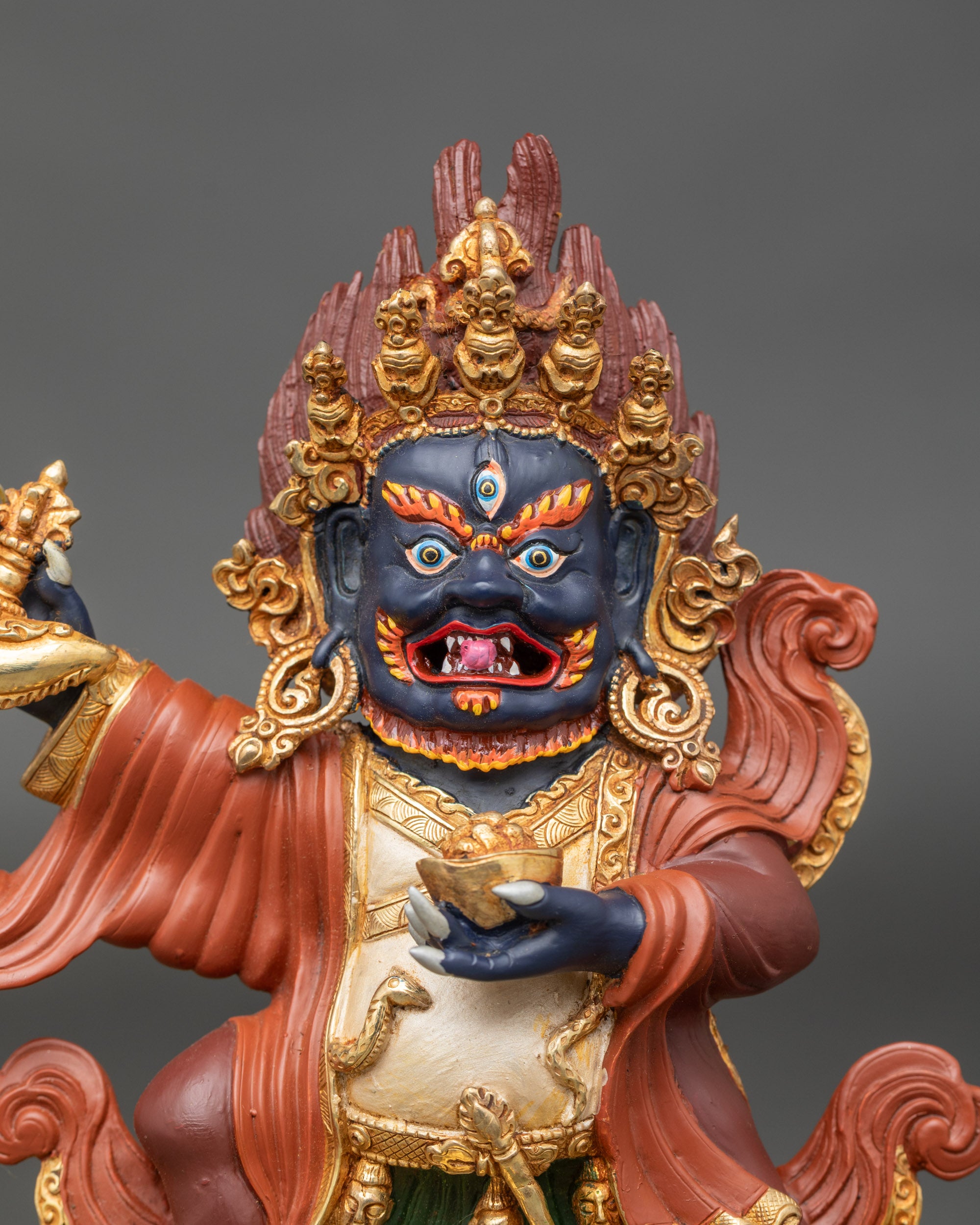 Close up Mahakala Bernagchen face with five-skull crown, flaming halo, and intricate details