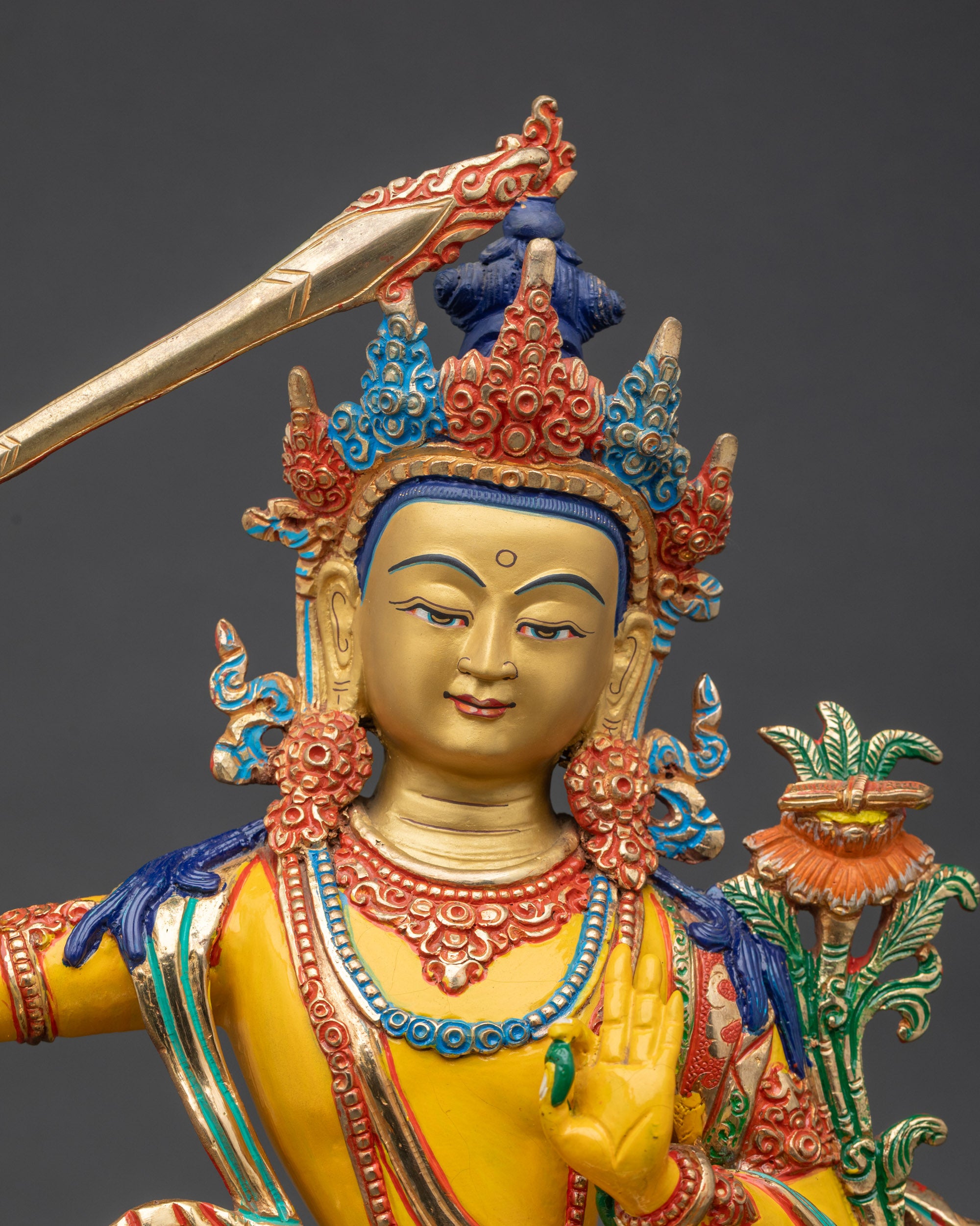 Close up Manjushree face with serene expression and 24K gold detailing