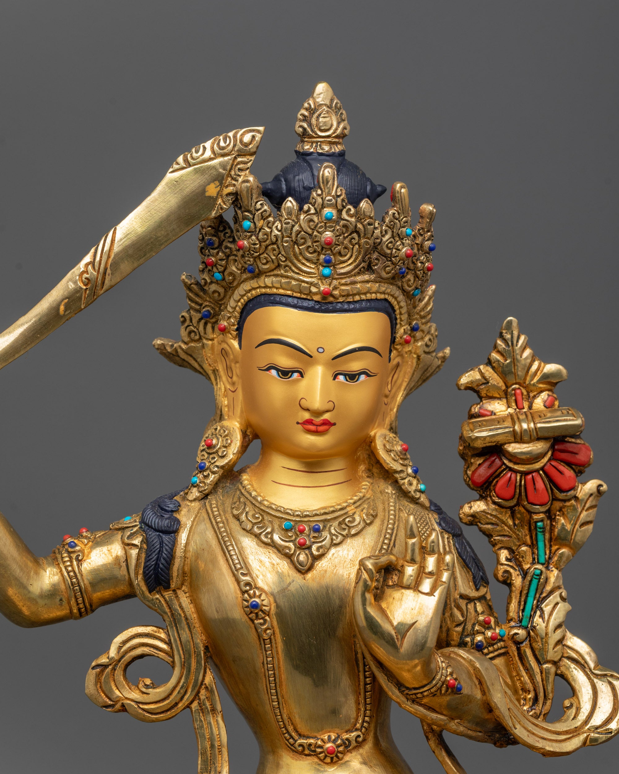 Close up Manjushri Bodhisattva holding flaming sword and Prajnaparamita text