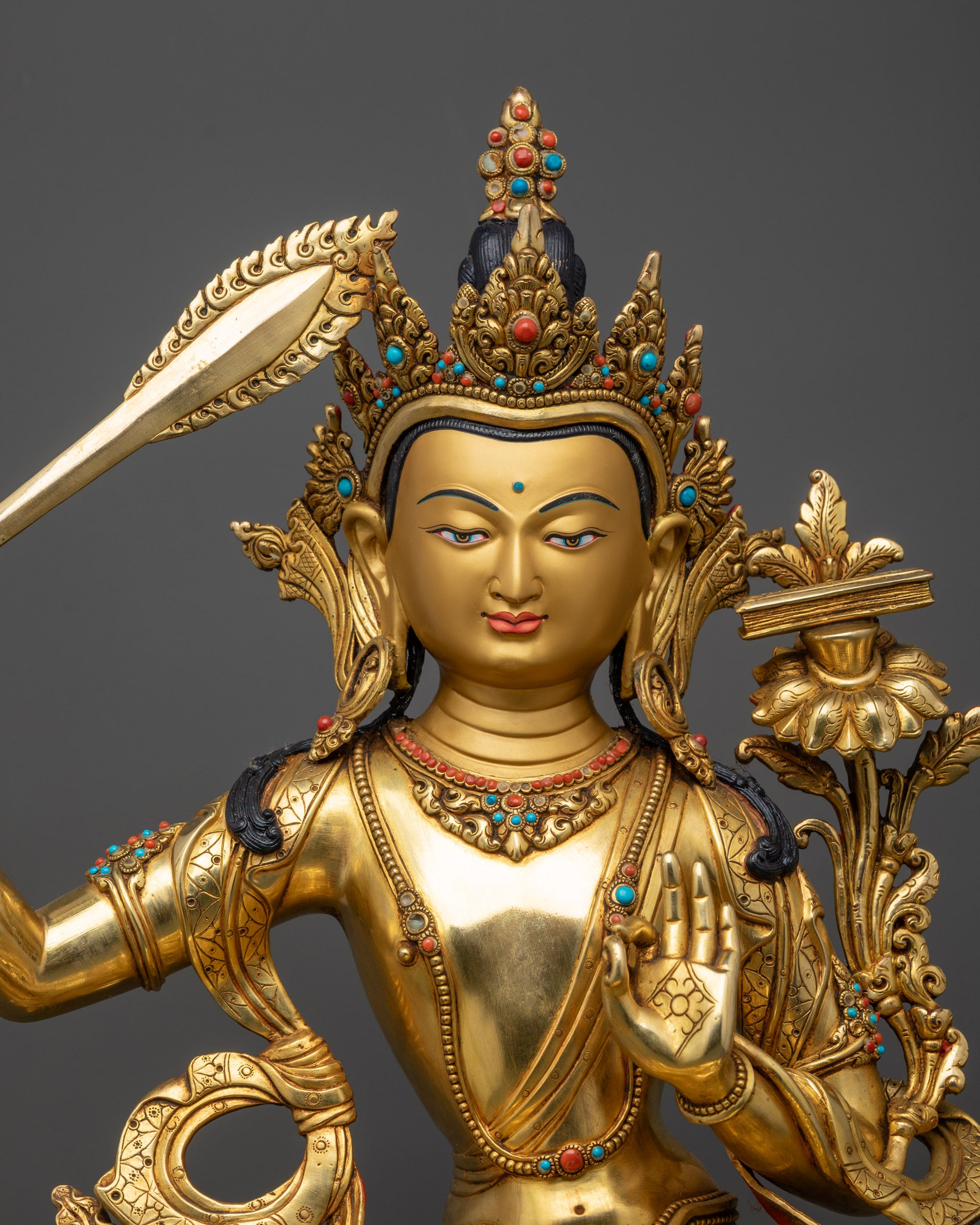 Close up Manjushri Sculpture showing intricate crown, jewelry, and flowing robes details
