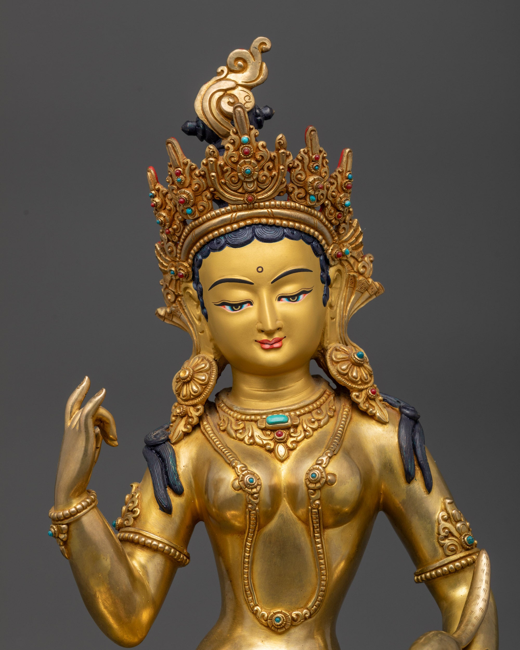 Close up Red Tara Kurukulla holding ankusha staff and jewel-spitting mongoose