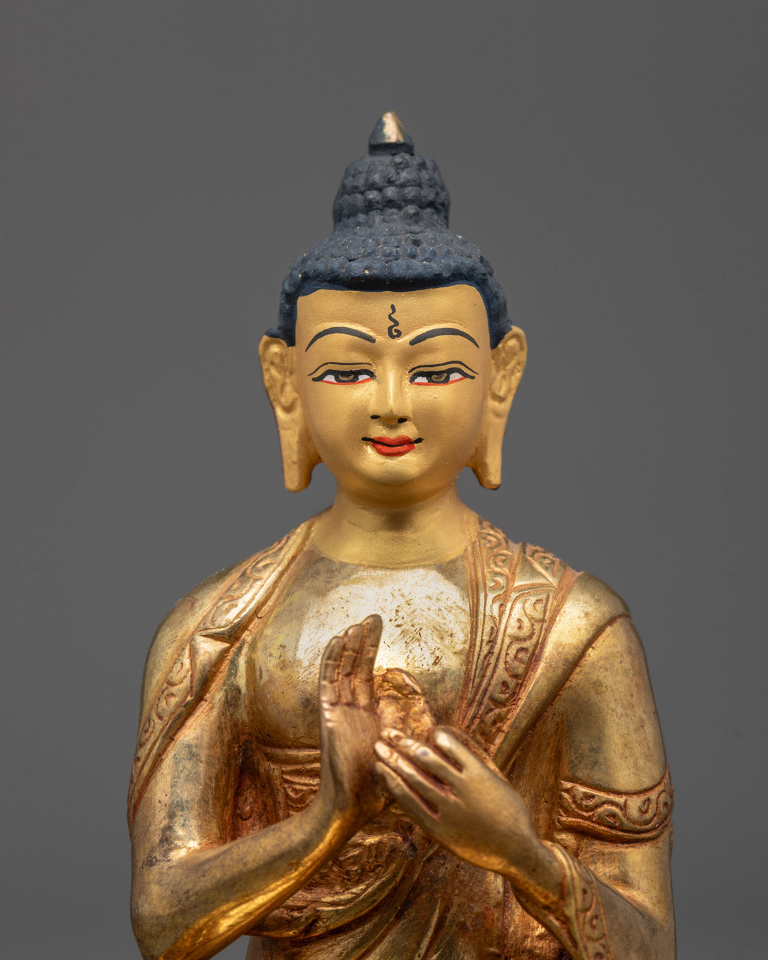 Close up Sacred Vairocana Buddha Sculpture showing Dharma Wheel Mudra and fine details