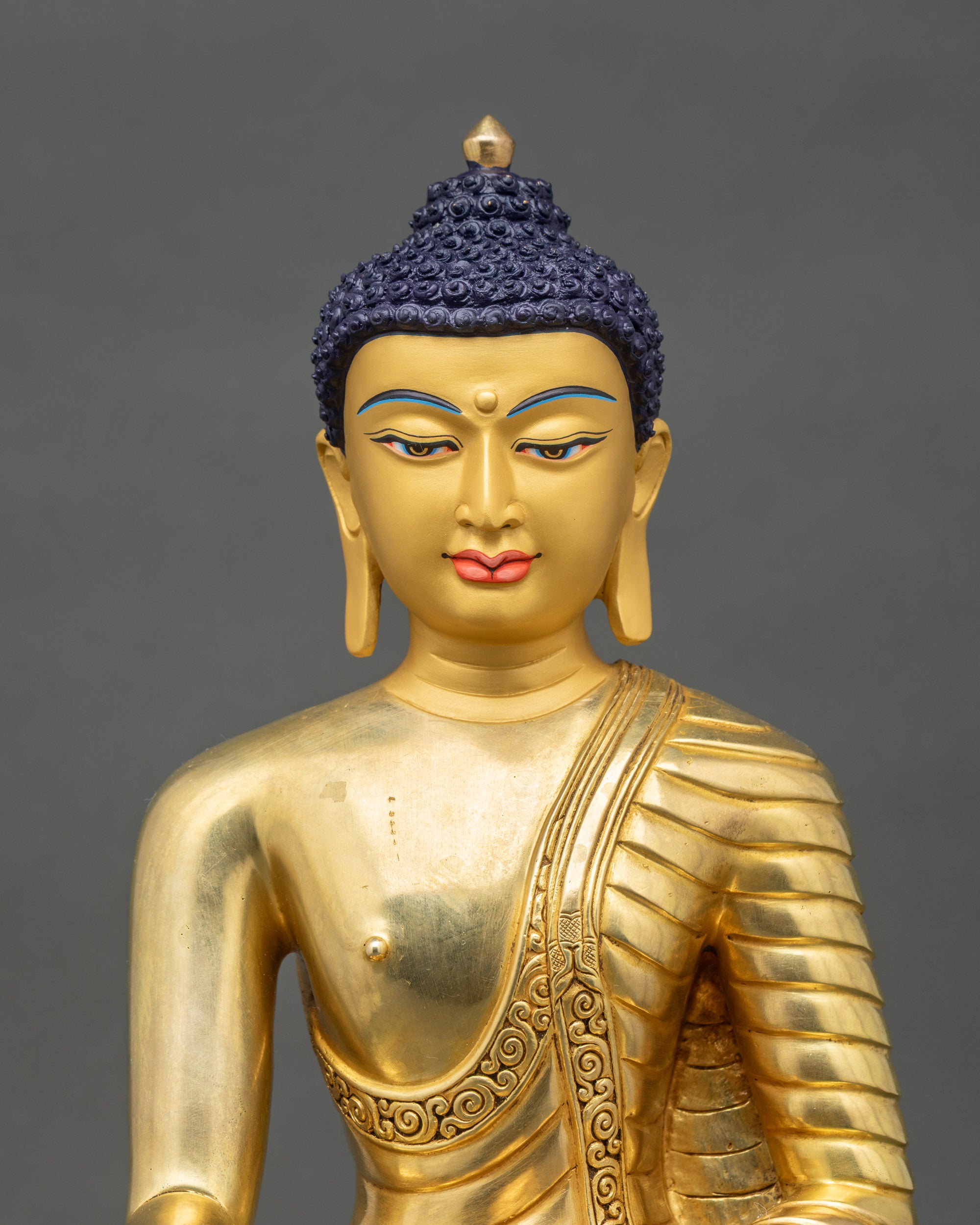 Close up Shakyamuni Buddha gold-painted face