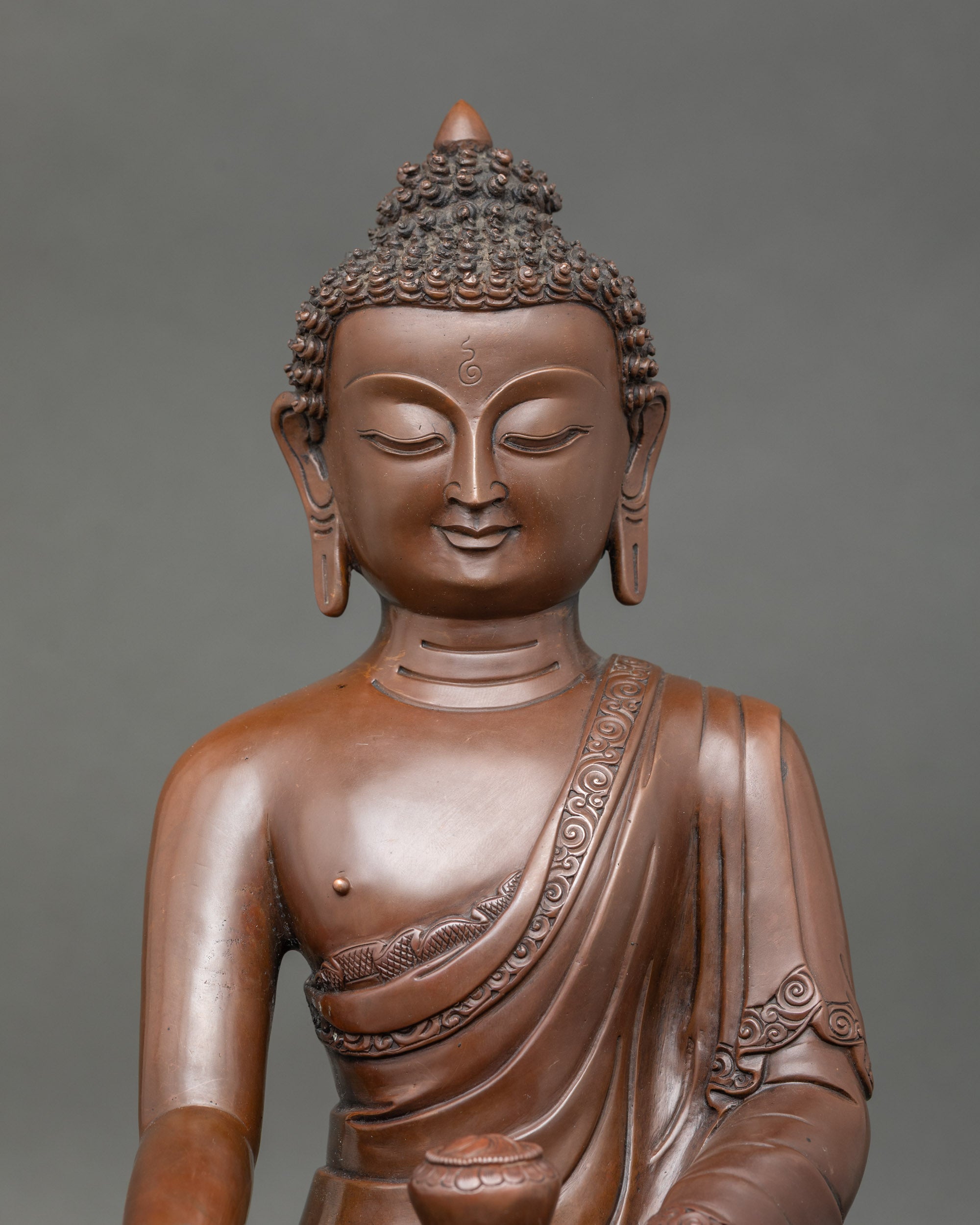 Close up Shakyamuni Buddha sculpture handcrafted in Nepal with oxidized copper details