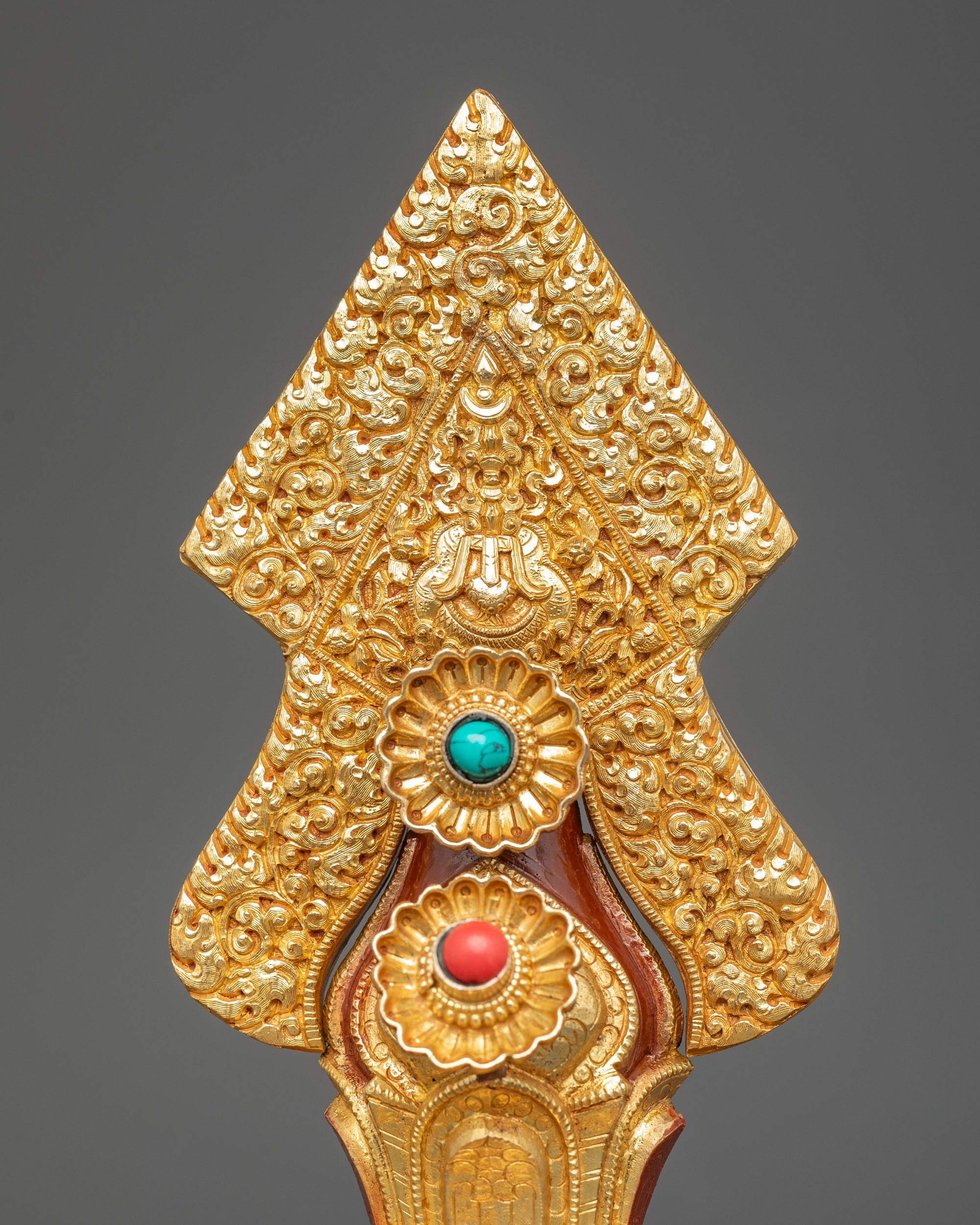 Close up Tibetan Torma with acrylic colors gold plating and semi precious stone details