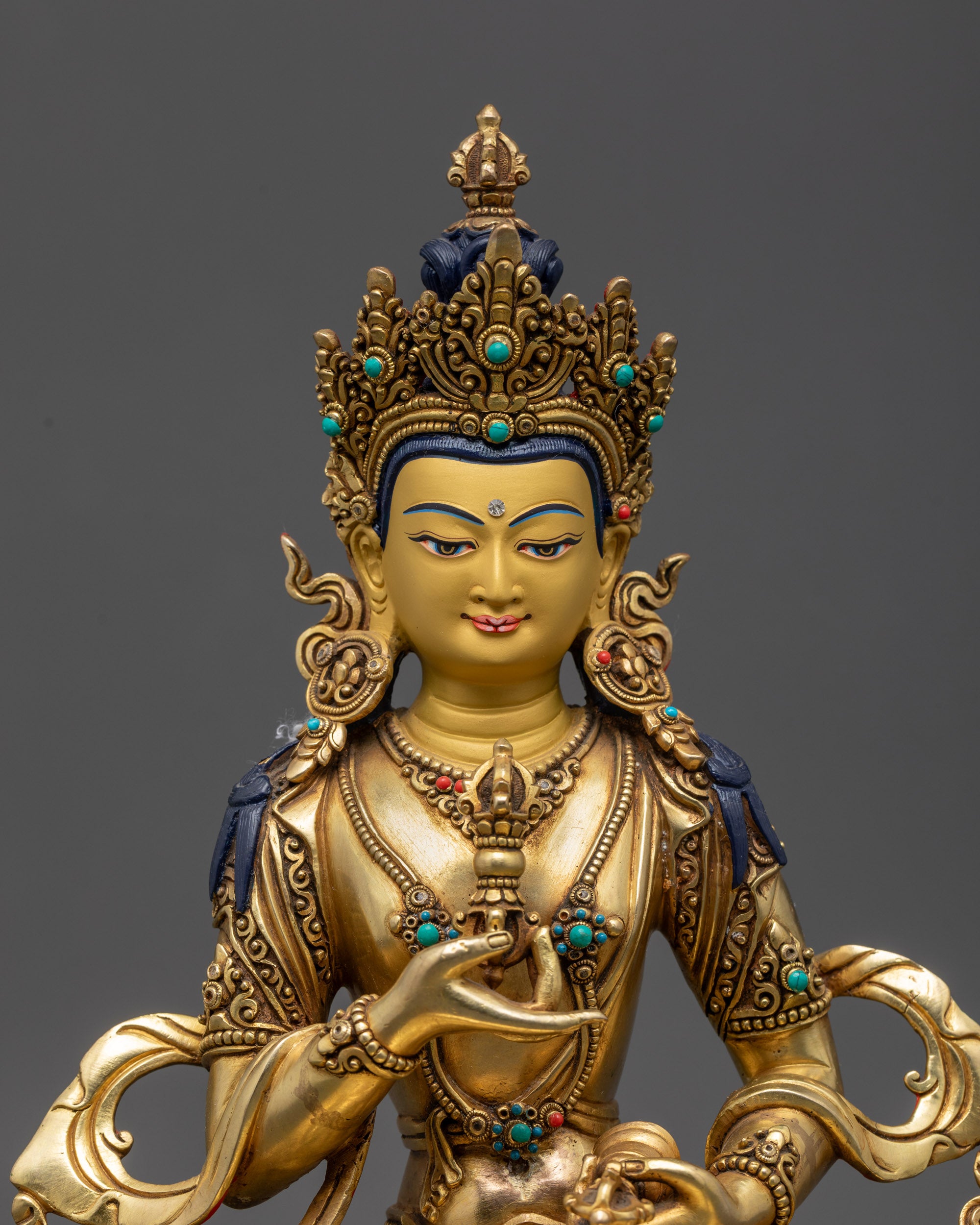 Close up Vajrasattva Statue calm expression with vajra bell and Five-Jeweled Crown