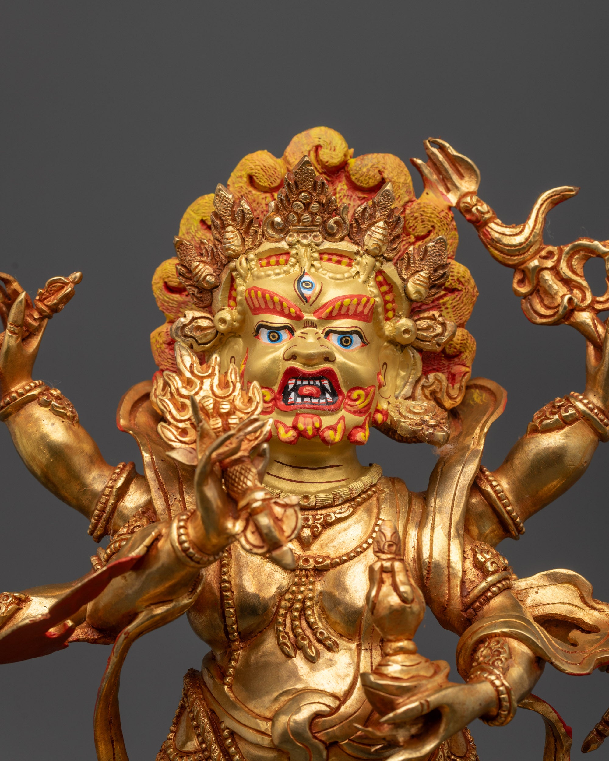Close up White Mahakala showing six arms holding sacred objects and fierce details