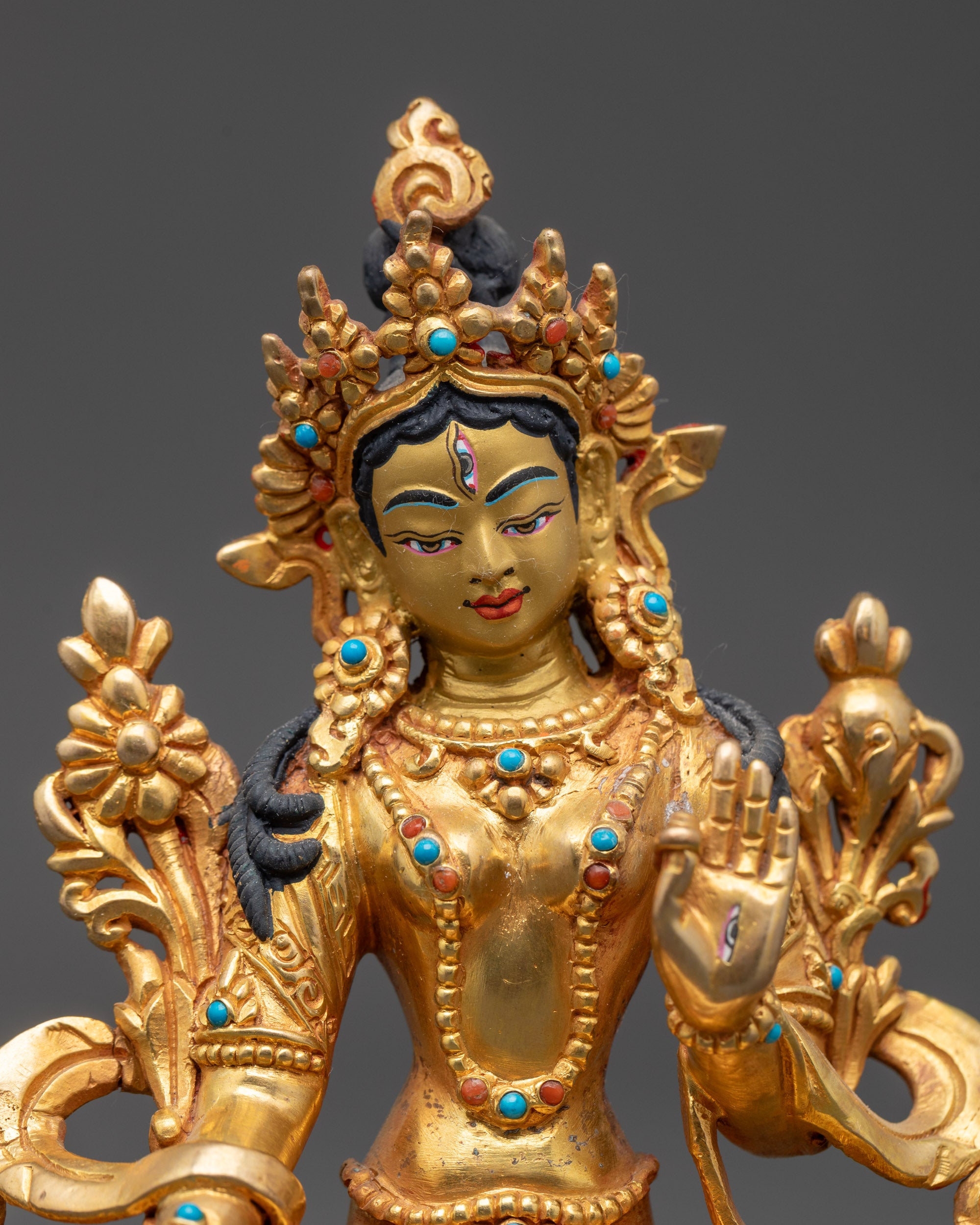 Close up White Tara statue showing all-seeing seven eyes and detailed hand gestures