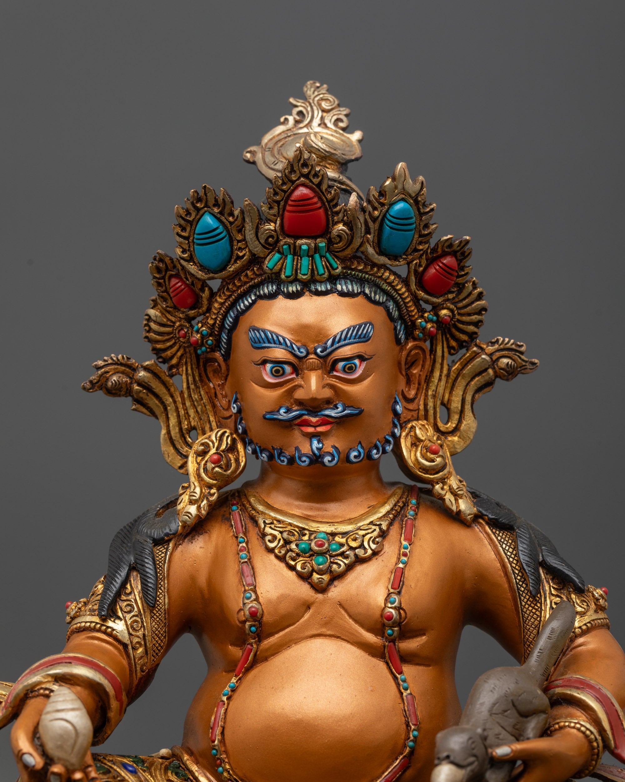 Close up Yellow Dzambhala face with semi wrathful expression and orange body