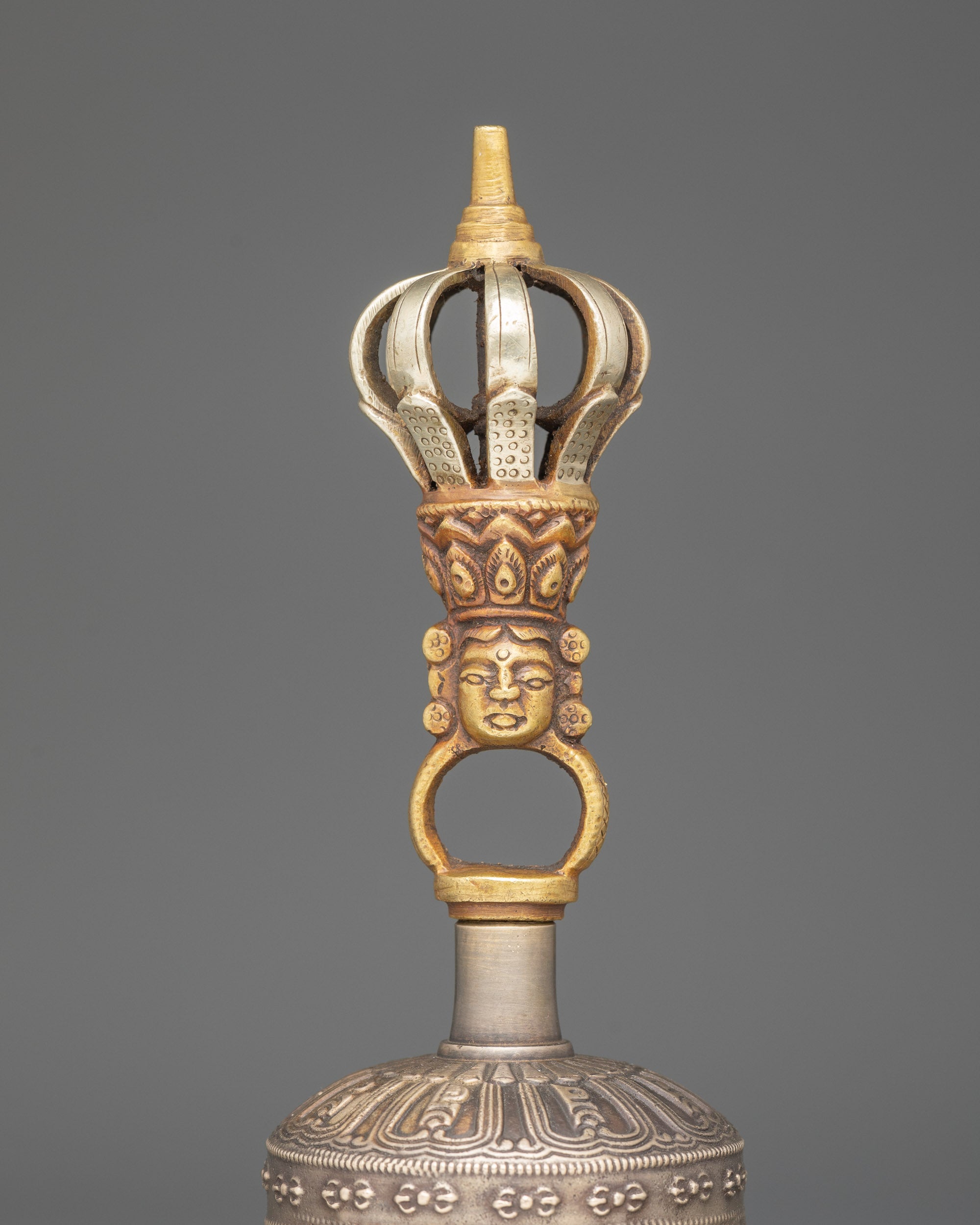 Close up bronze bell handle with deity carving | Copper Vajra and intricate patterns