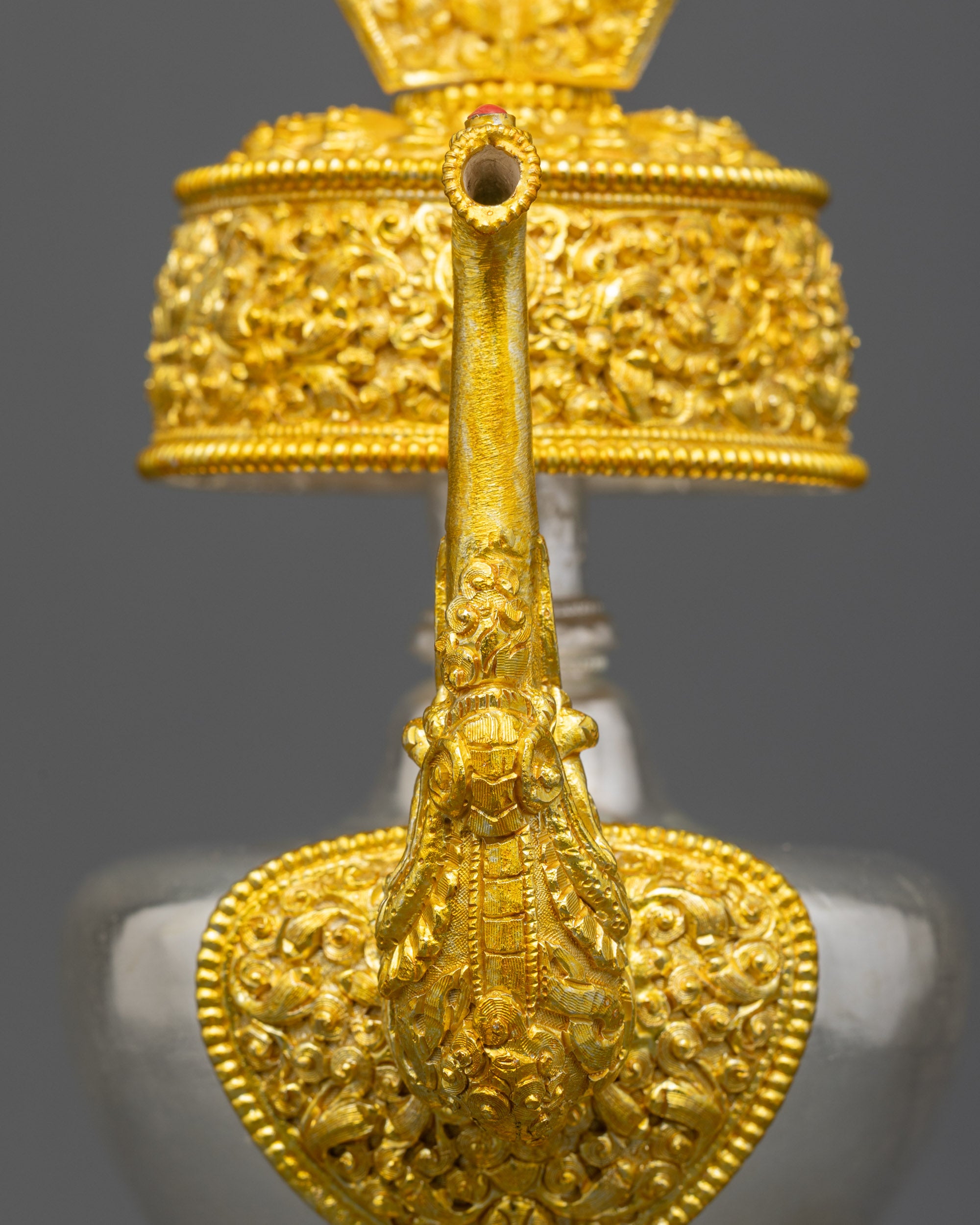 Close up dragon-head spout on one Bhumba offering vase