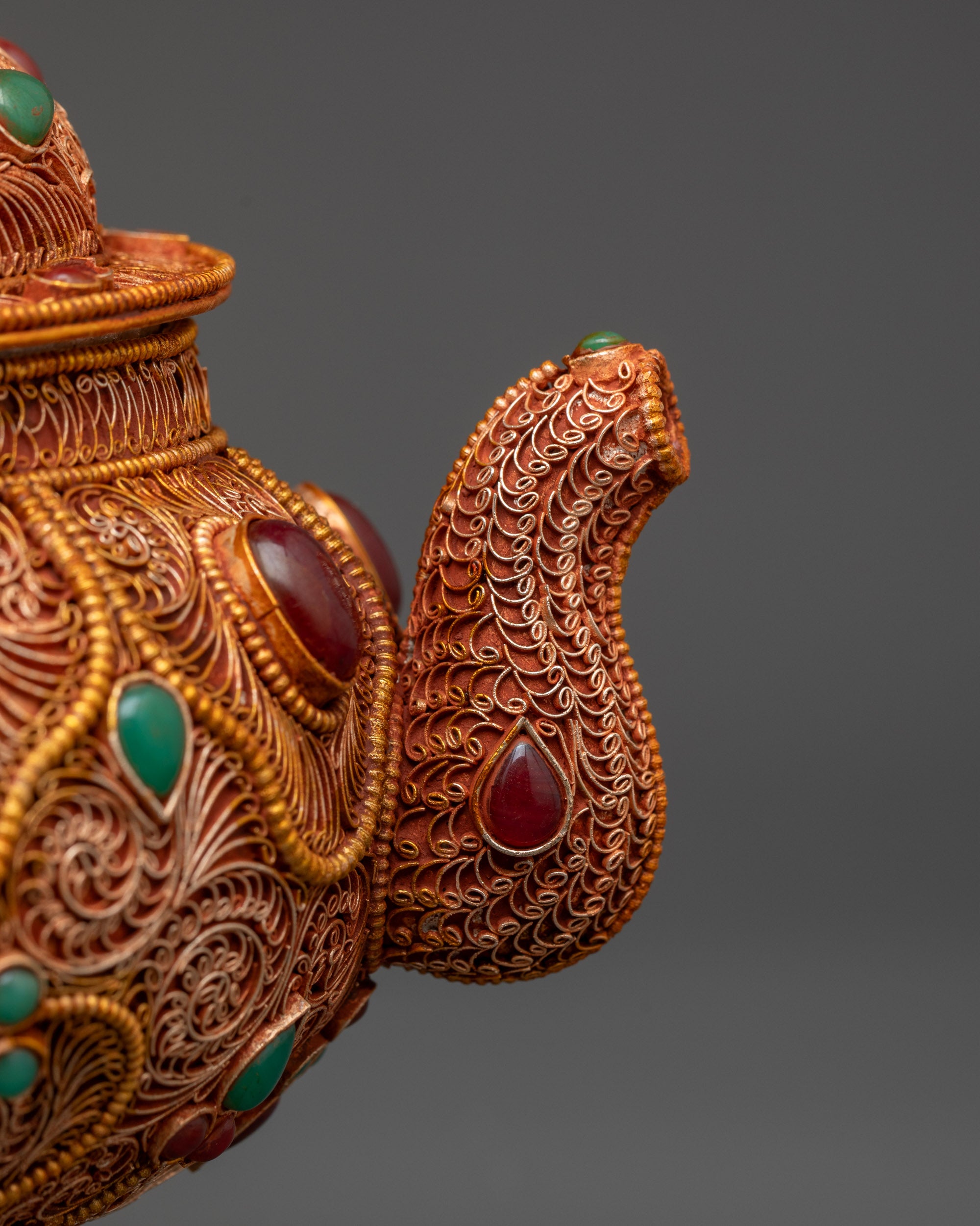 Close up gemstone-adorned Tibetan Tea Pot with intricate copper and gold detailing