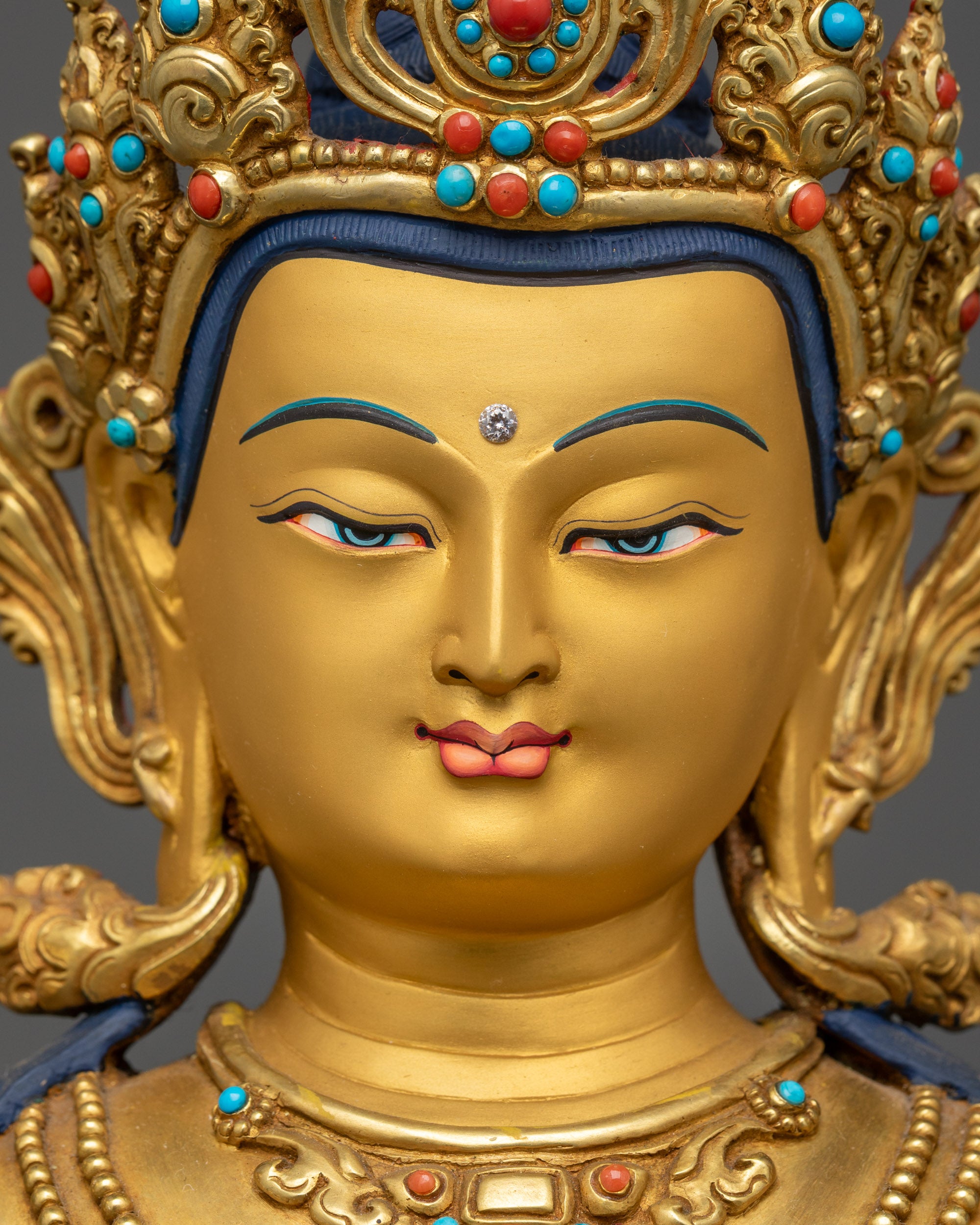 Close up gold-gilded face of Manjushri Bodhisattva with five-jeweled crown