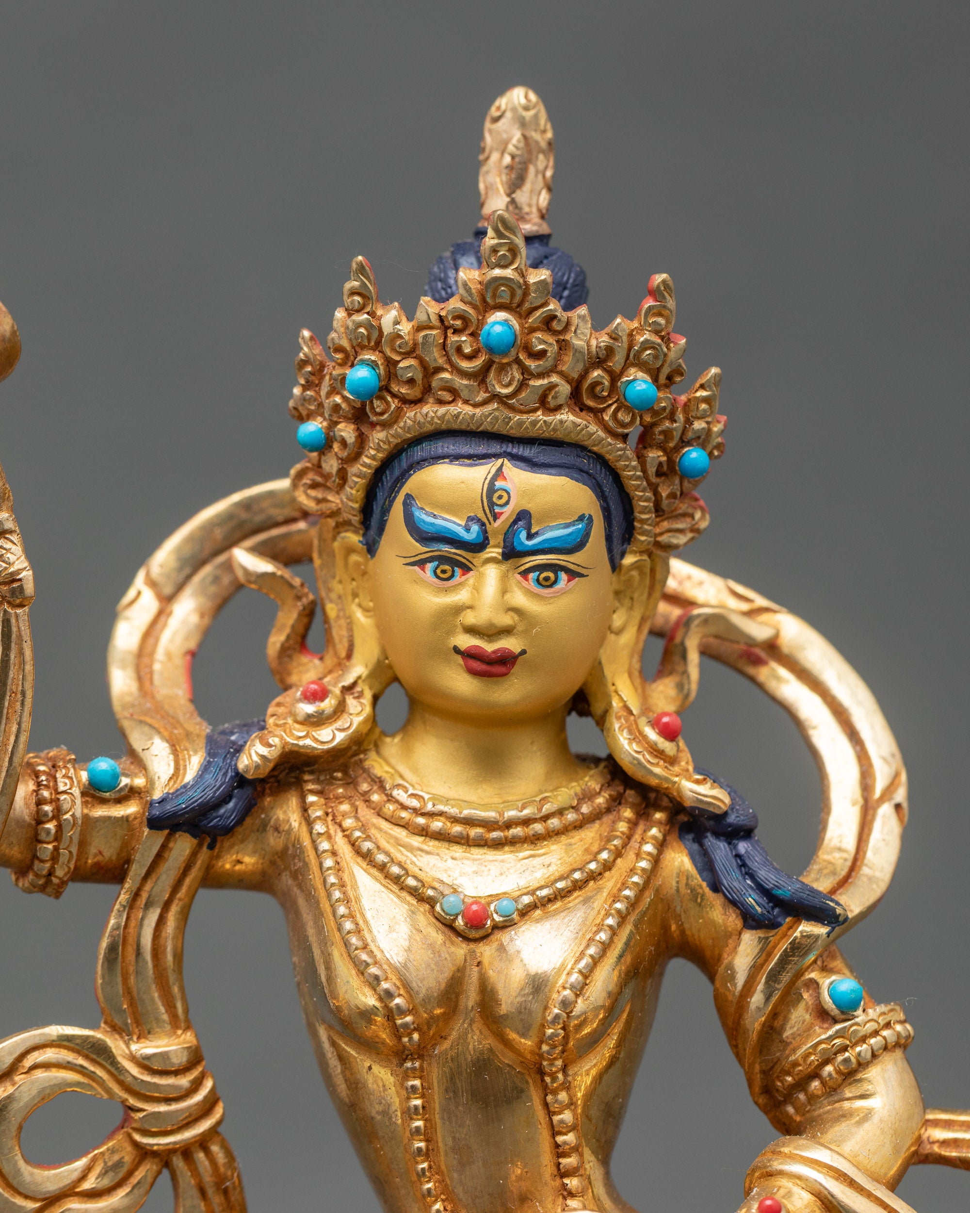 Close up gold-painted face Machig Labdron Buddhist goddess handcrafted Nepal