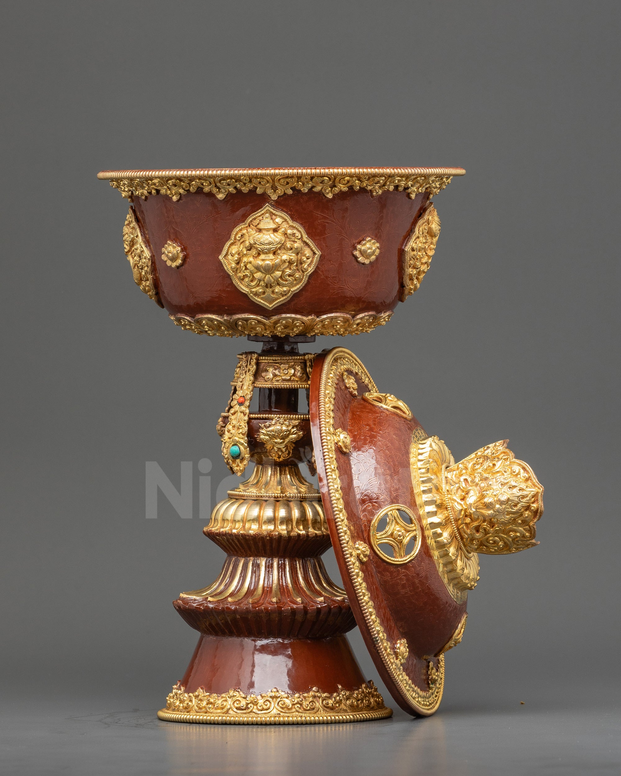 Close up hand-painted colors and coral turquoise stones on copper Himalayan butter lamp