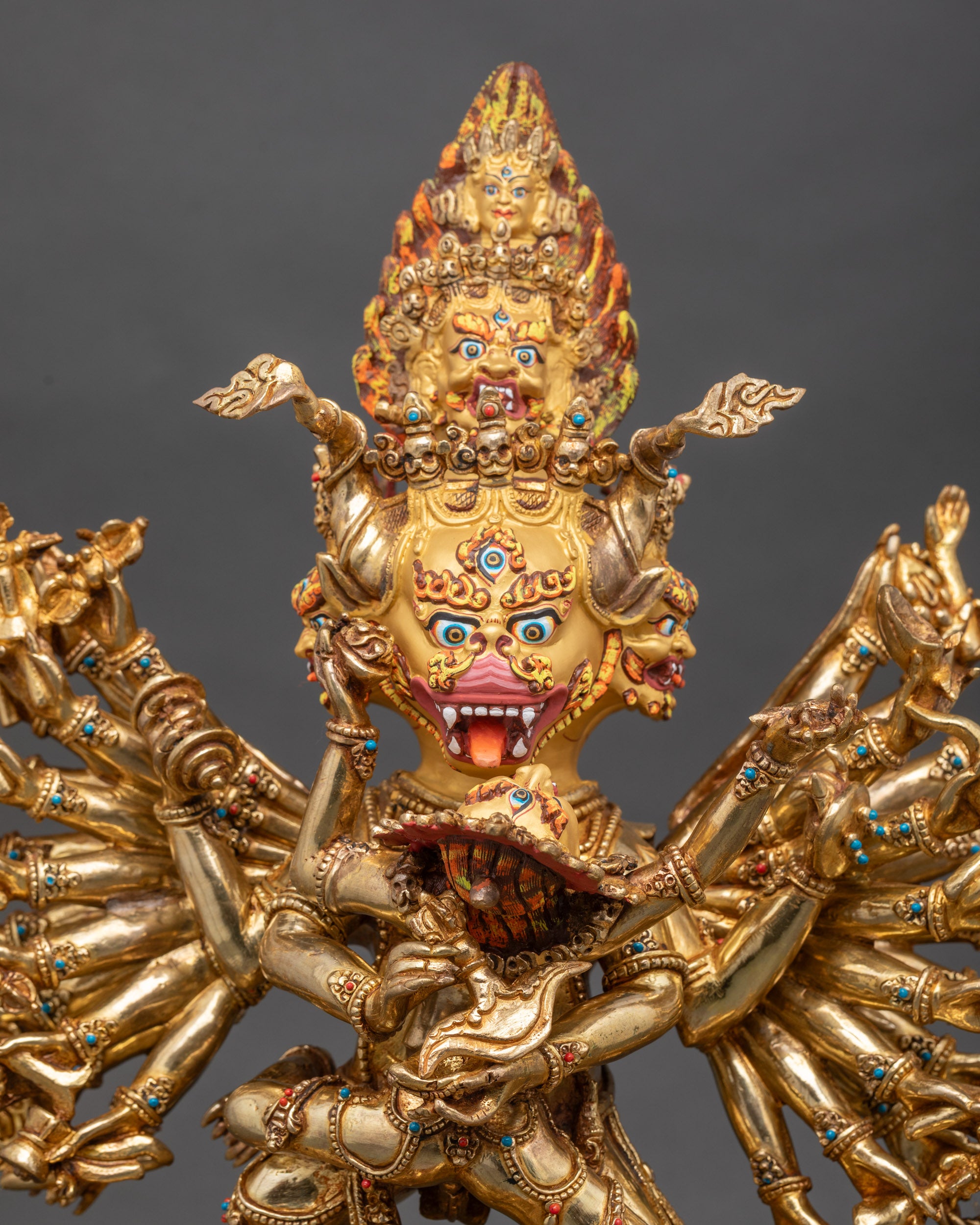 Close up nine-faced Yamantaka with wrathful expression and gold-painted face