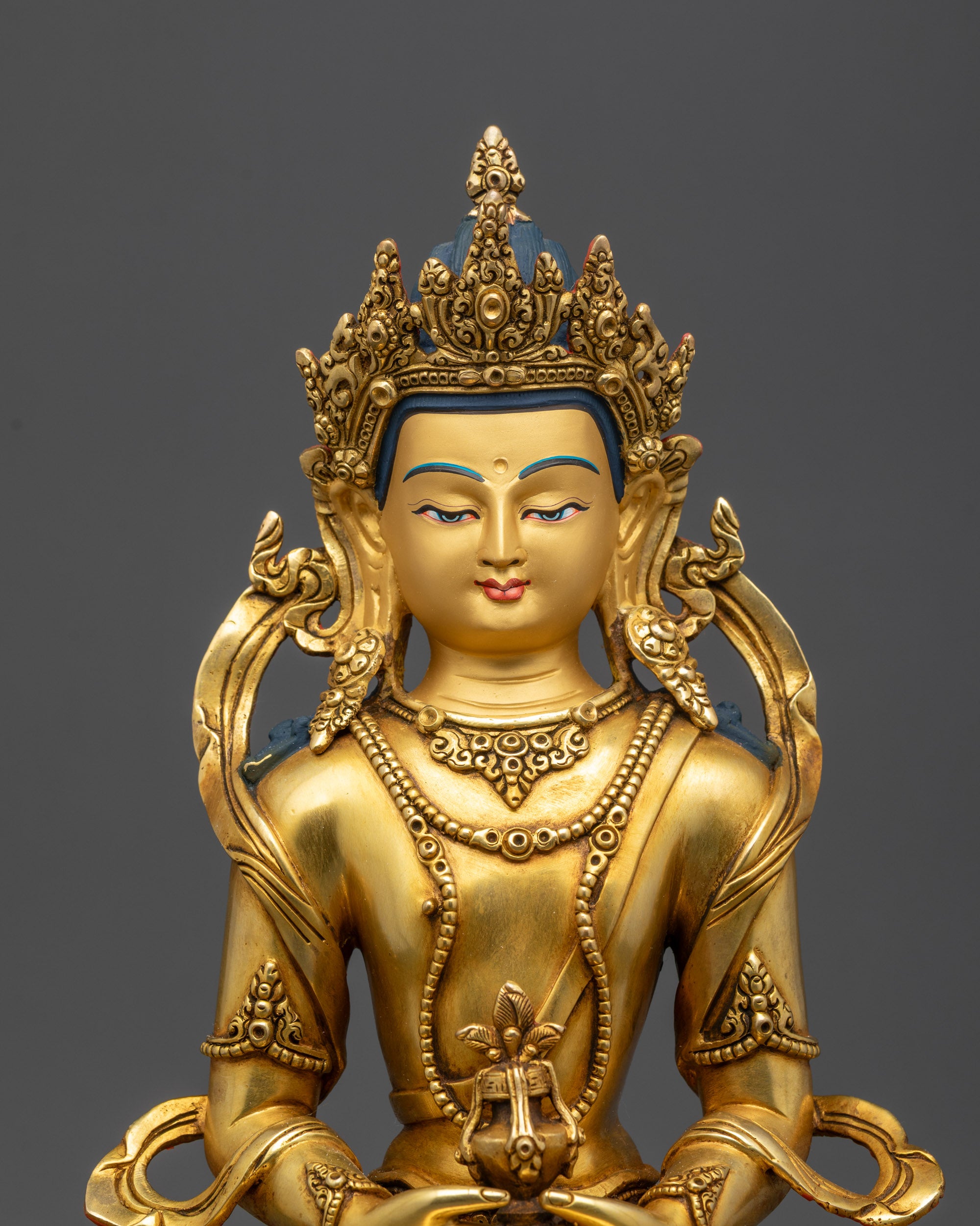 Close up of Amitayus Buddha face showing gold gilding and serene expression