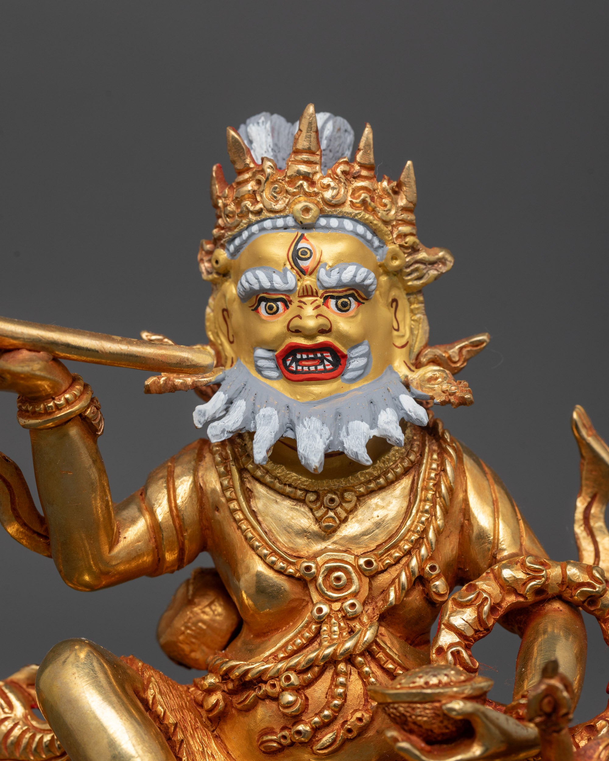 Close up of Brahmanrupa Mahakala statue face showing third eye and gold-gilded details