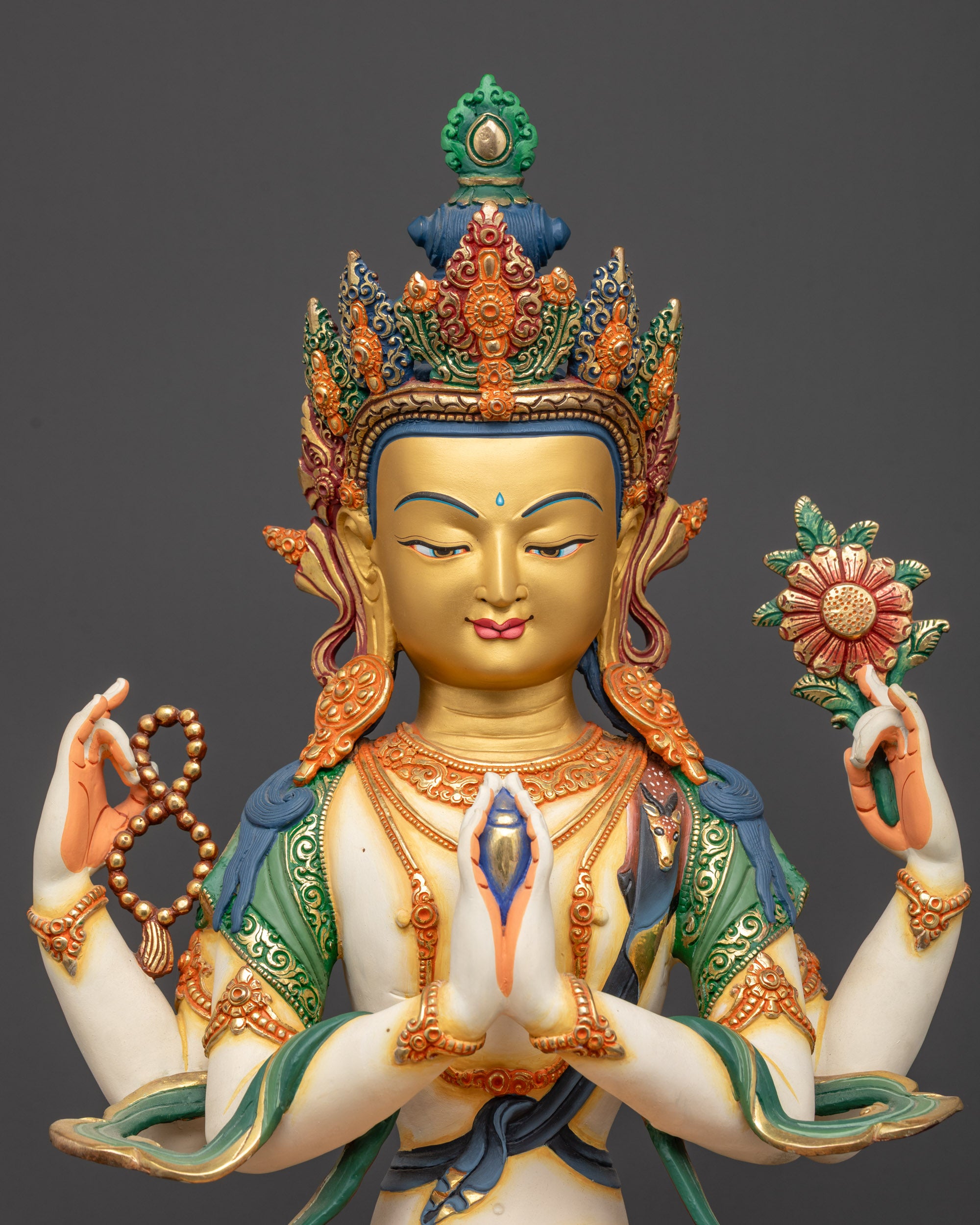 Close up of Chenrezig statue highlighting hand-painted crown and jewelry