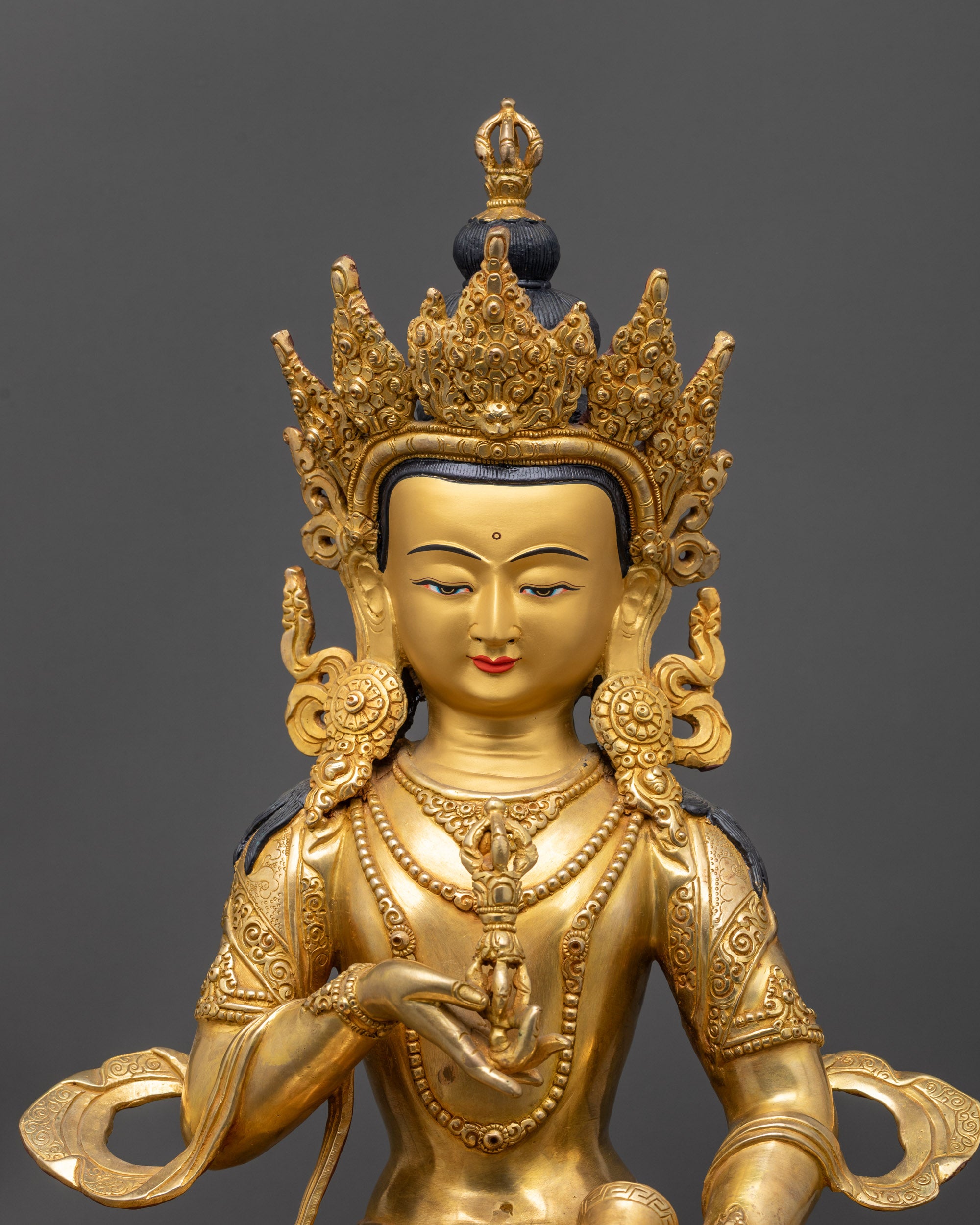 Close up of Dorje Sempa statue showing swirling robes and mandala floral patterns