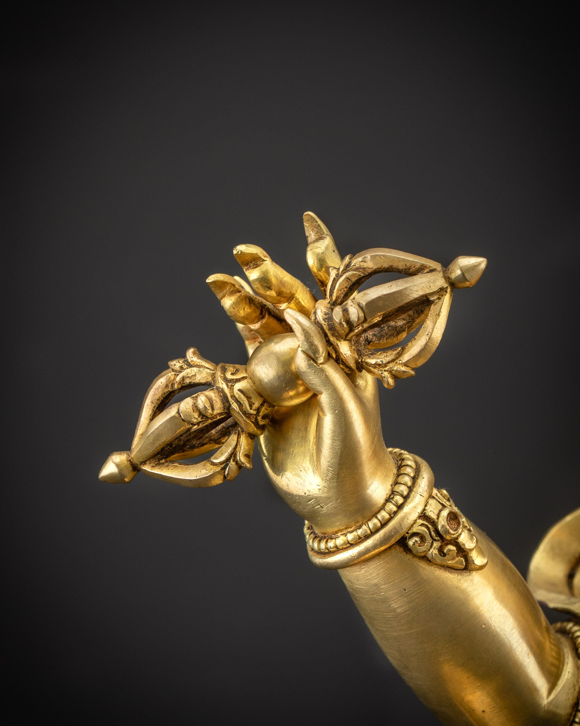 Close up of Dorje in Vajrapani statue’s hand with intricate carvings