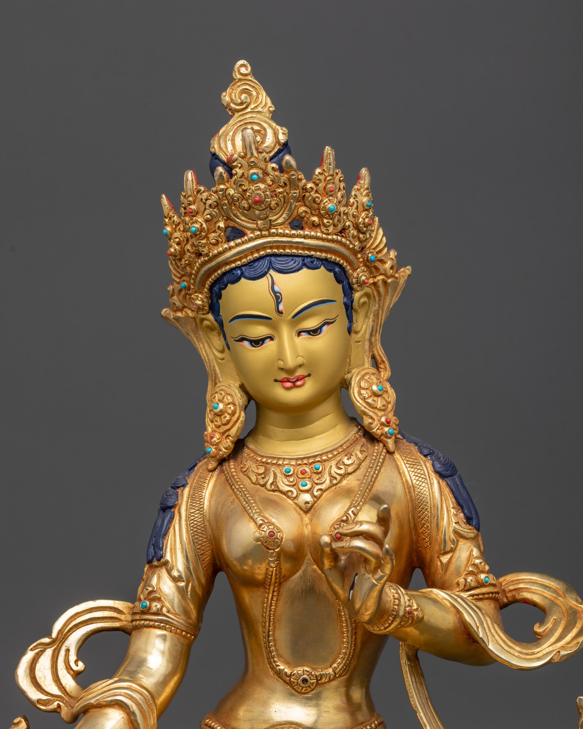 Close up of Dukar statue showing third eye, semi-precious stones, and intricate carvings