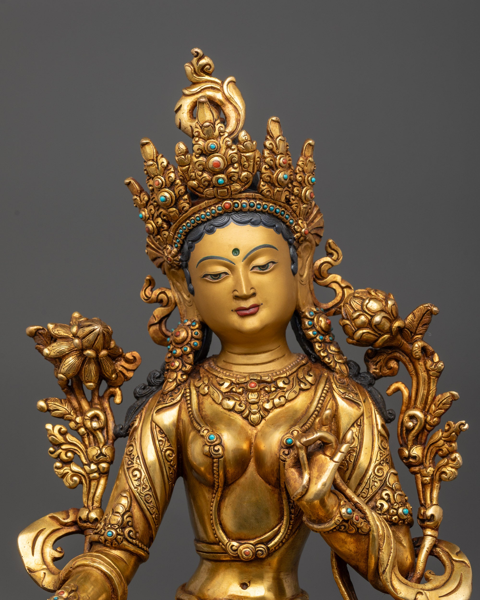 Close up of Green Tara’s five-jeweled crown and Utpala flower details