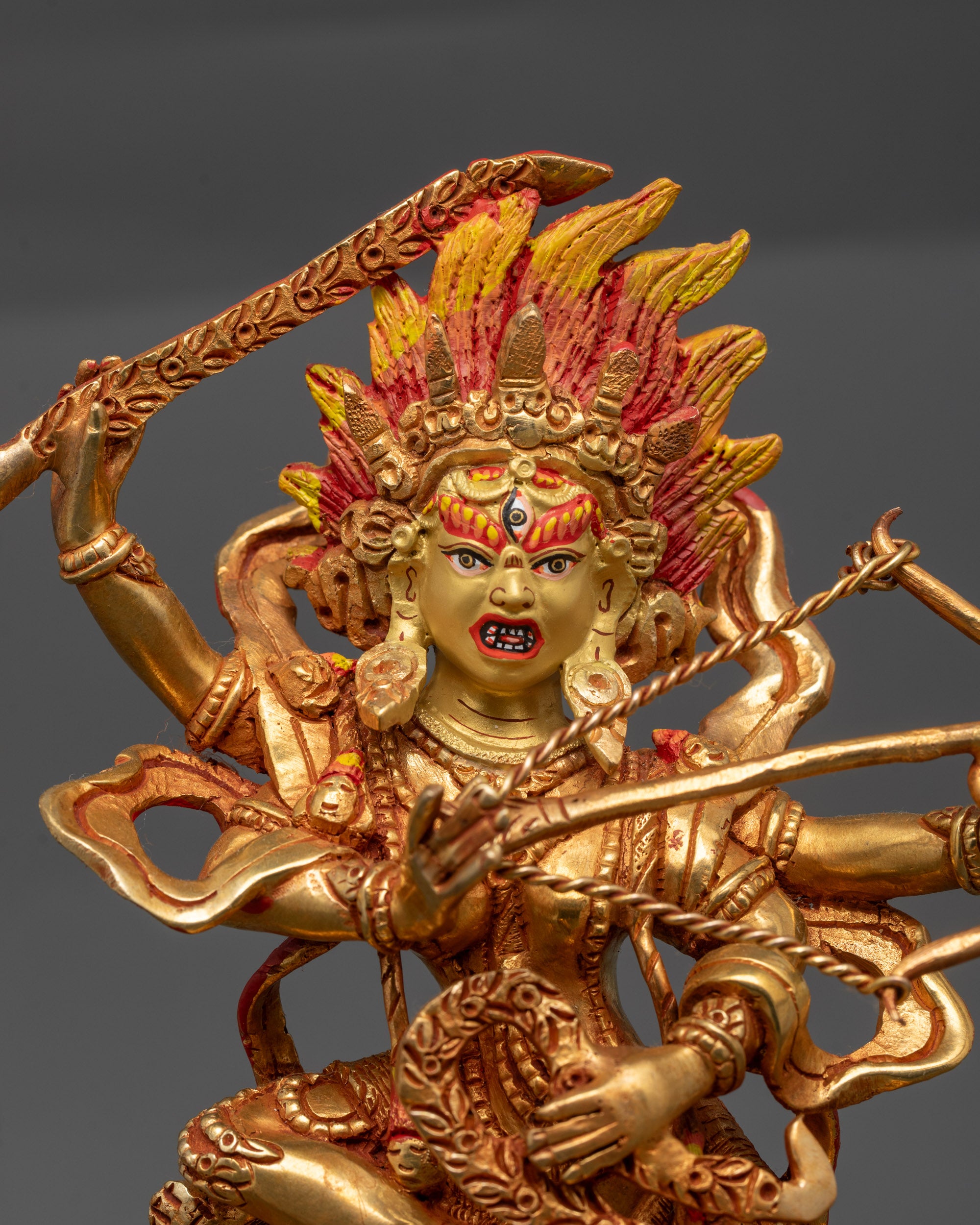 Close up of Kurukulla statue showing third eye, five-skull crown, and flower arrows