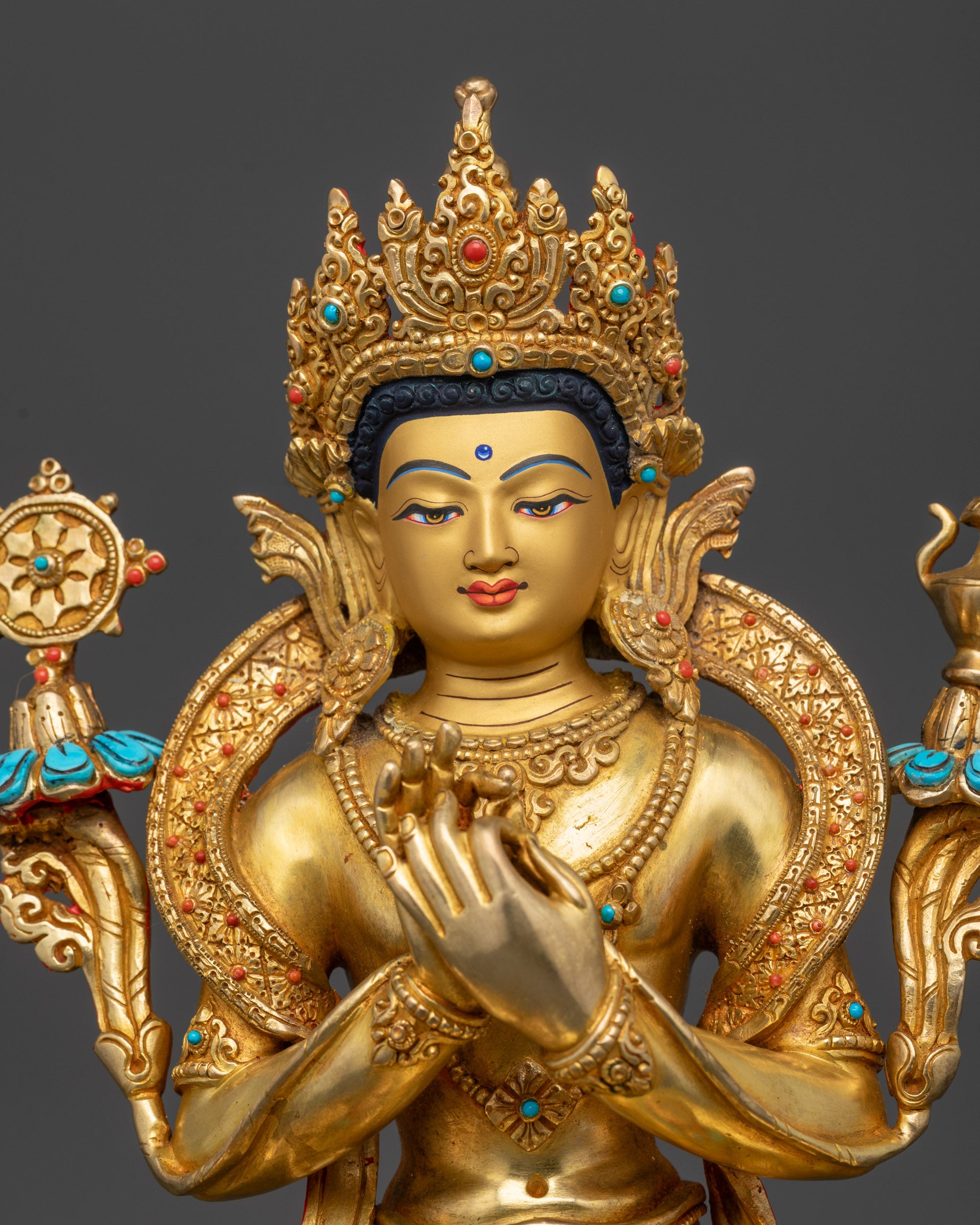 Close up of Maitreya Buddha statue showing crown, robes, and gold-gilded finish