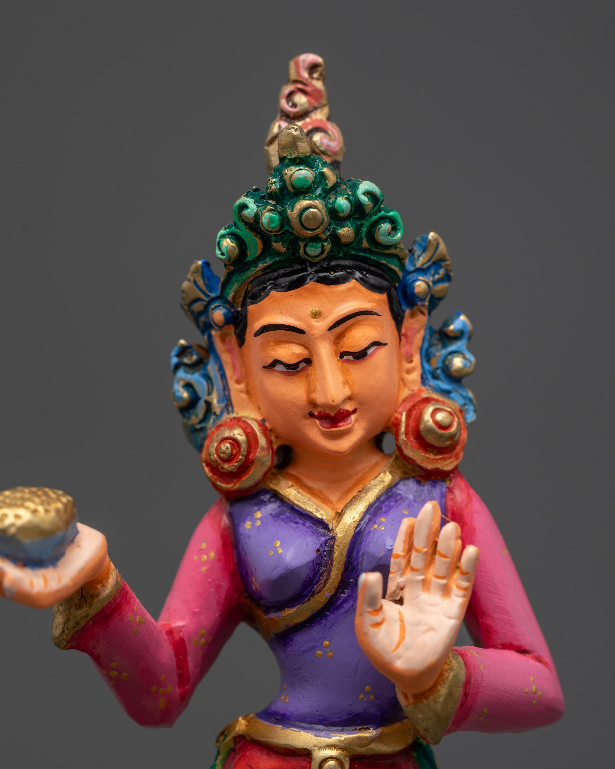 Close up of Mandarva disciple statue beside Guru Rinpoche on throne