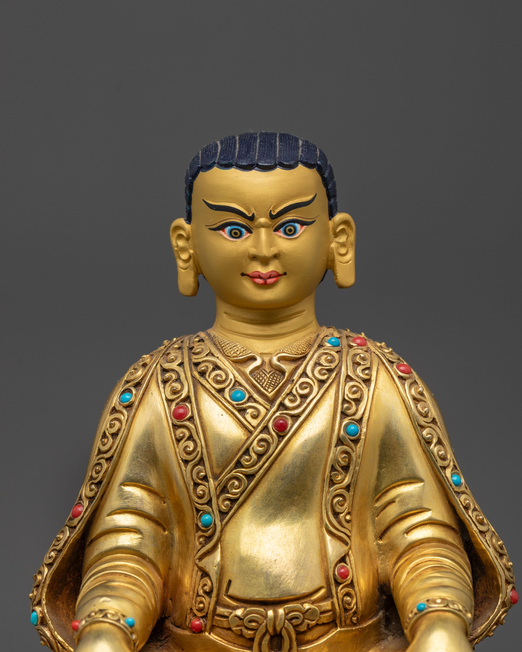 Close up of Marpa statue 24K gold gilded Tibetan Buddhist master handcrafted in Nepal lost wax figure.