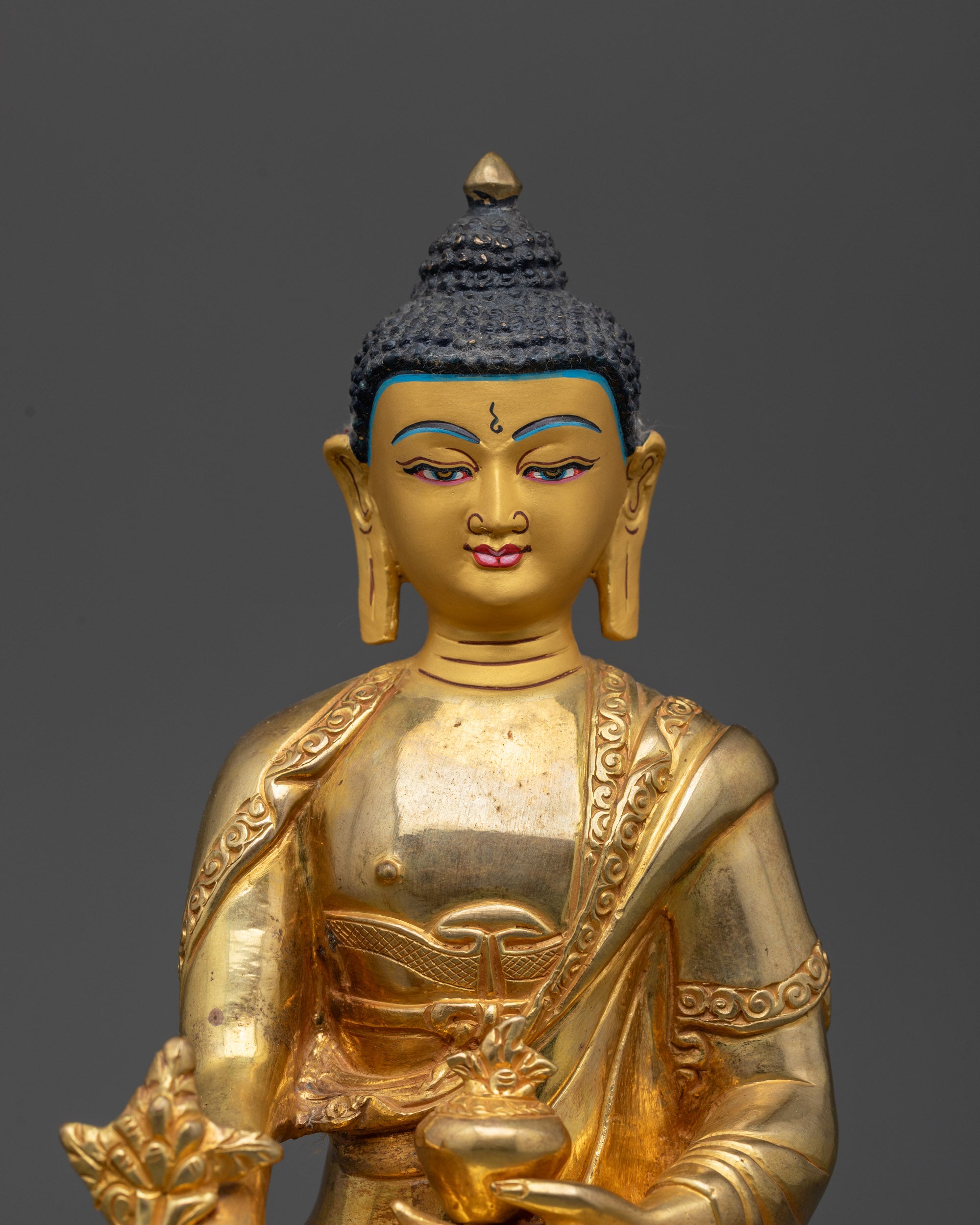 Close up of Medicine Buddha holding Myrobalan plant and medicine bowl in dhyana mudra