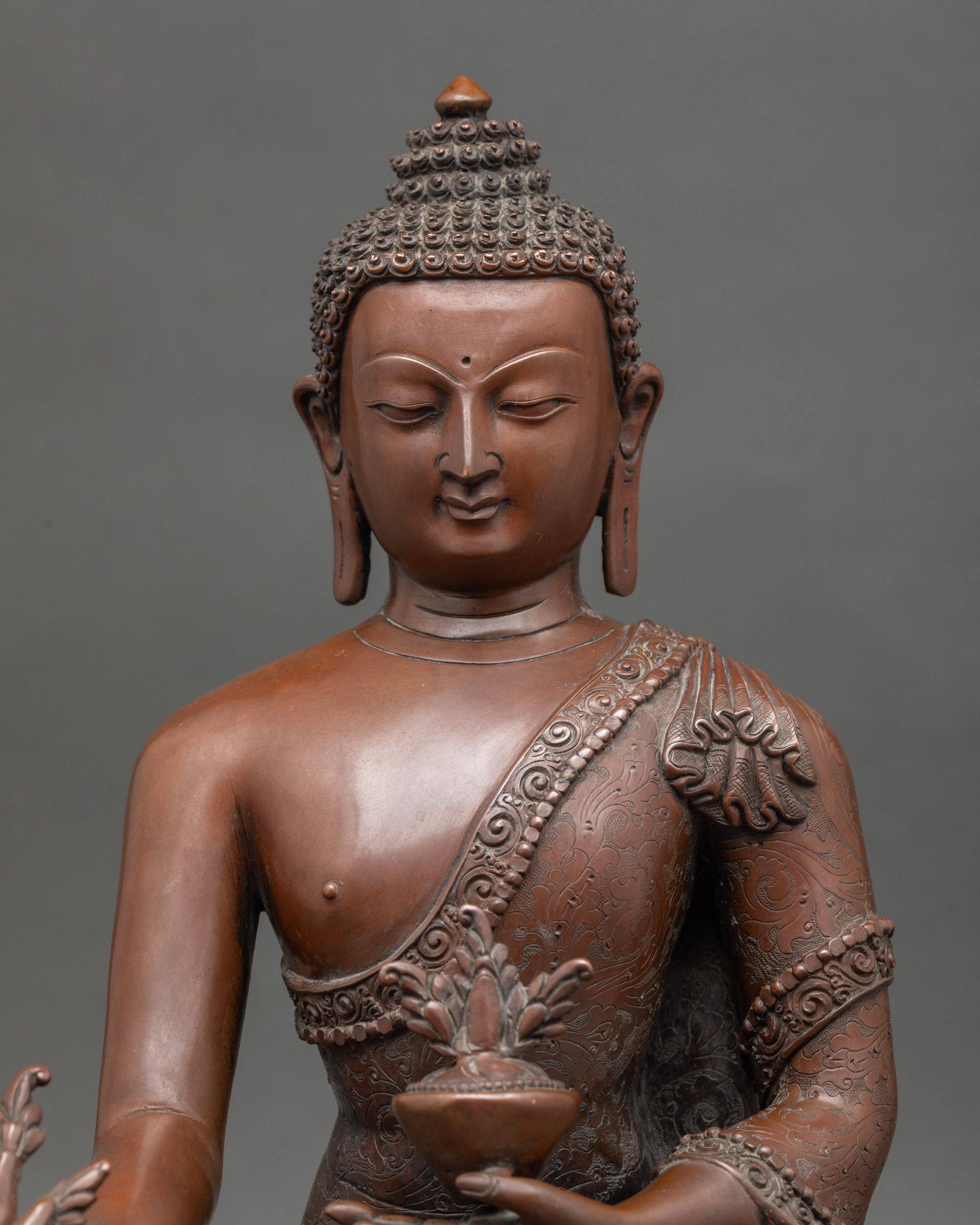 Close up of Medicine Buddha, holding healing nectar and myrobalan plant, double lotus seat