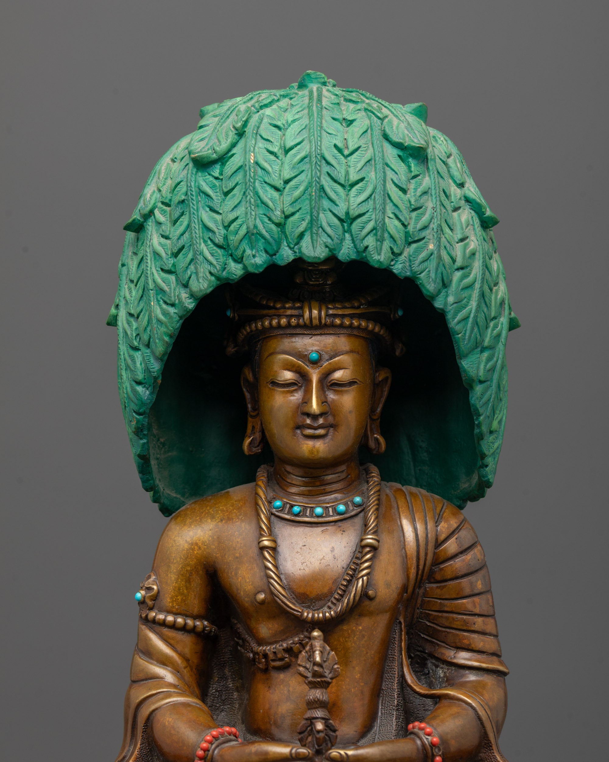 Close up of Mitrugpa statue showing semi precious stones and detailed craftsmanship