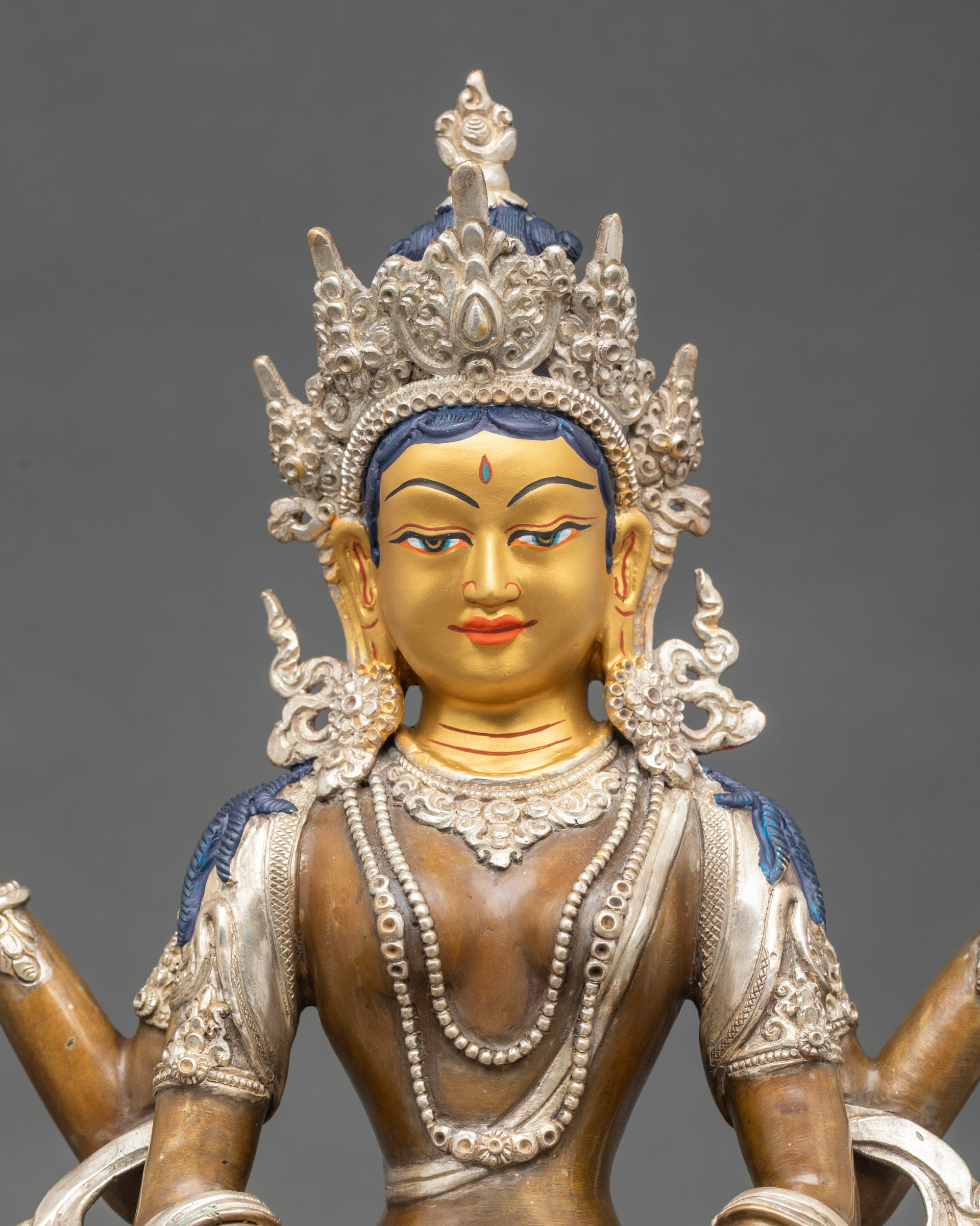 Close up of Prajnaparamita statue holding sutra and vajra