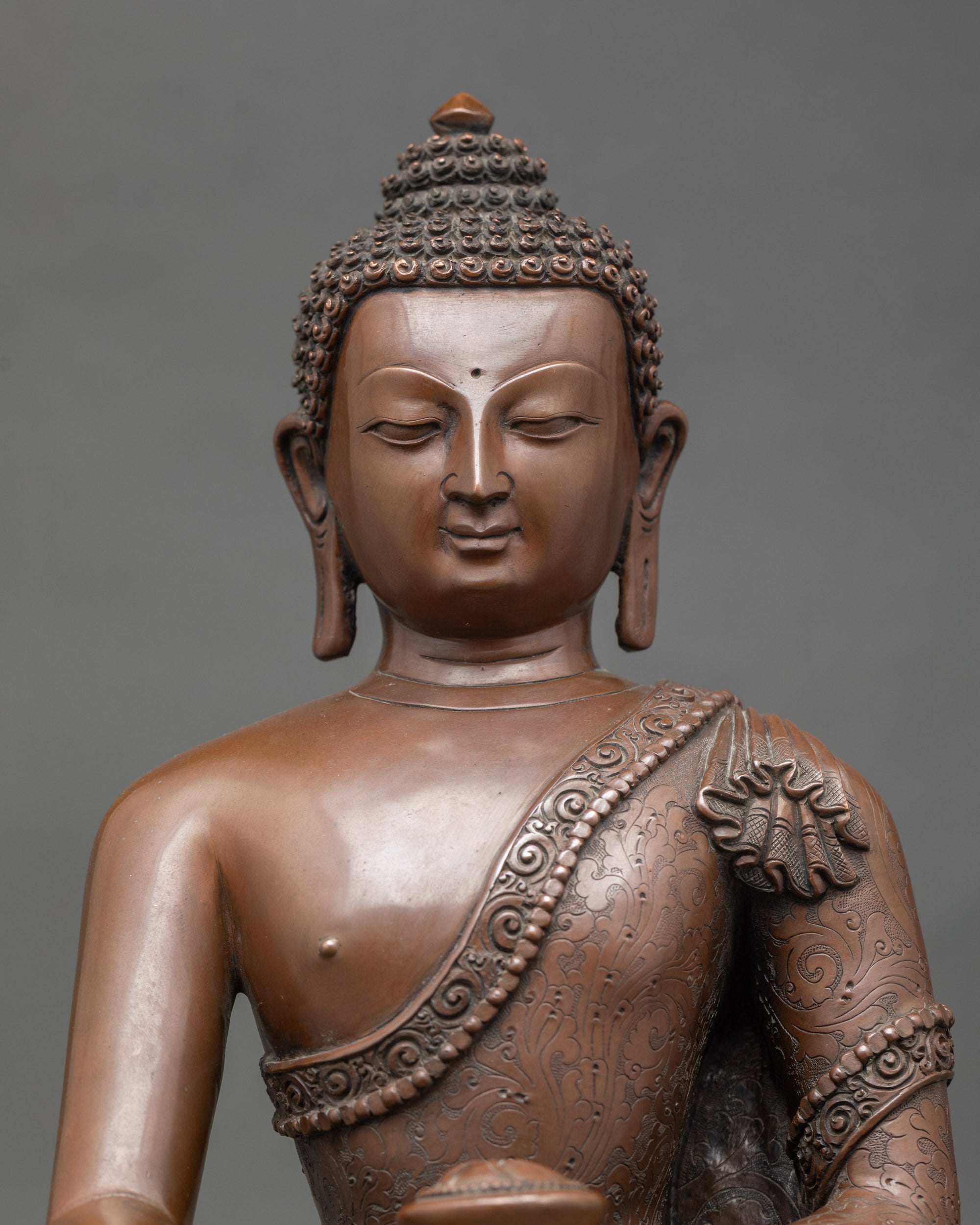 Close up of Shakyamuni Buddha face with serene expression and oxidized detail