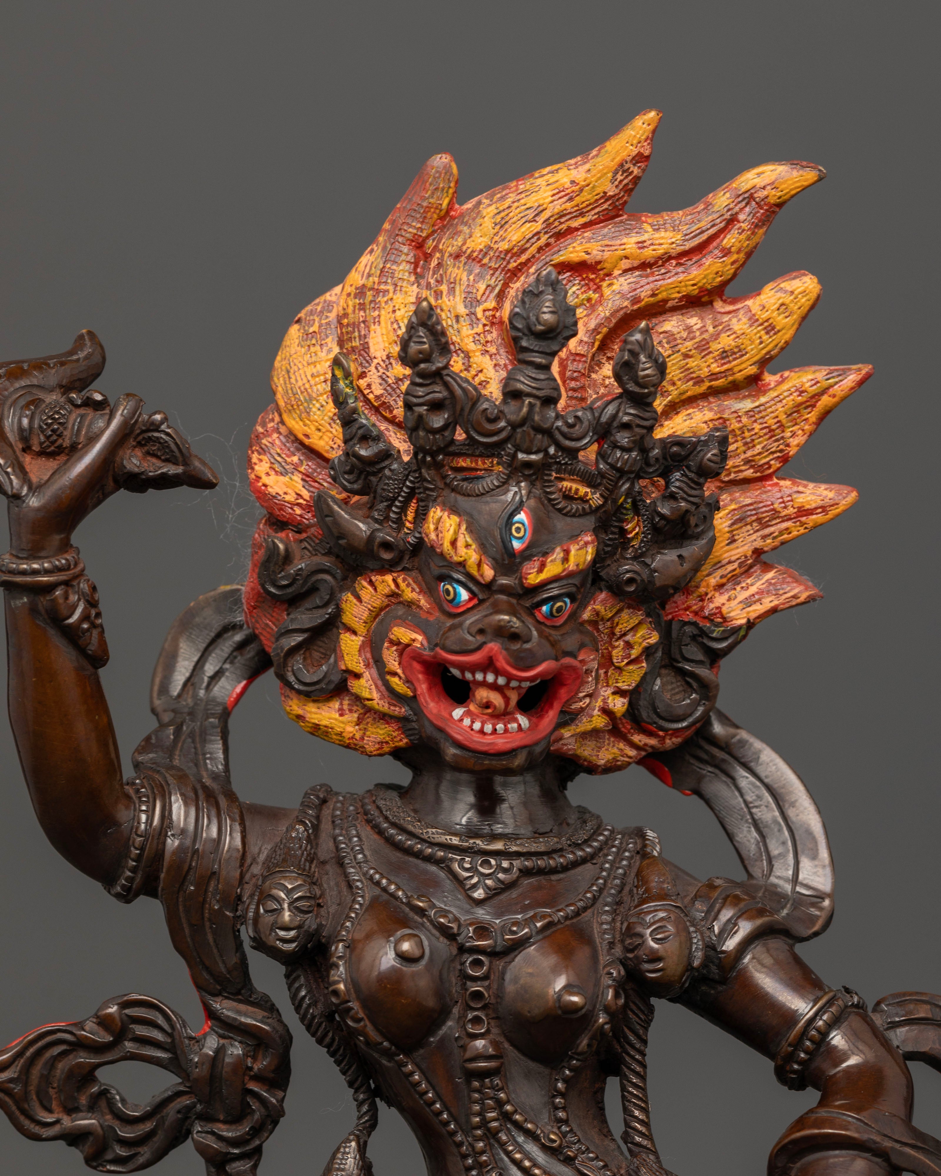 Close up of Simha Mukha statue highlighting intricate adornments and ritual implements
