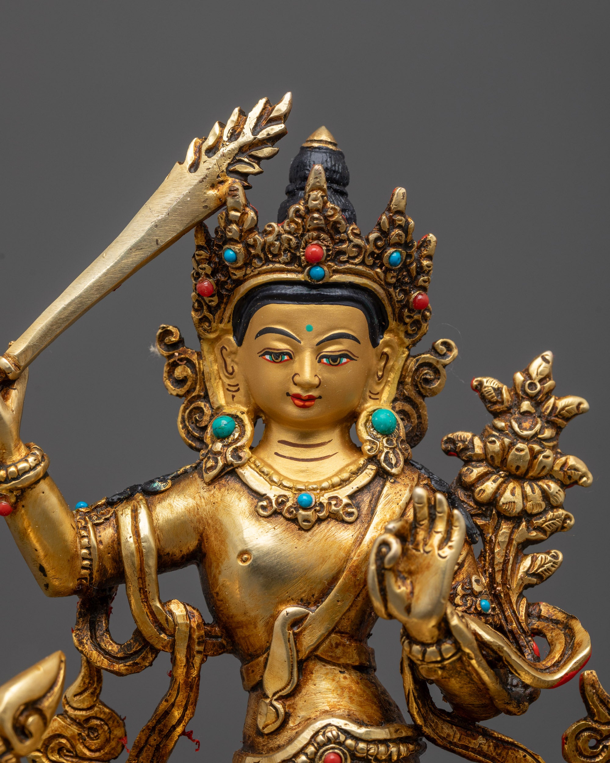 Close up of Simhada Manjushri Statue showing gold-fire gilded body and intricate carvings