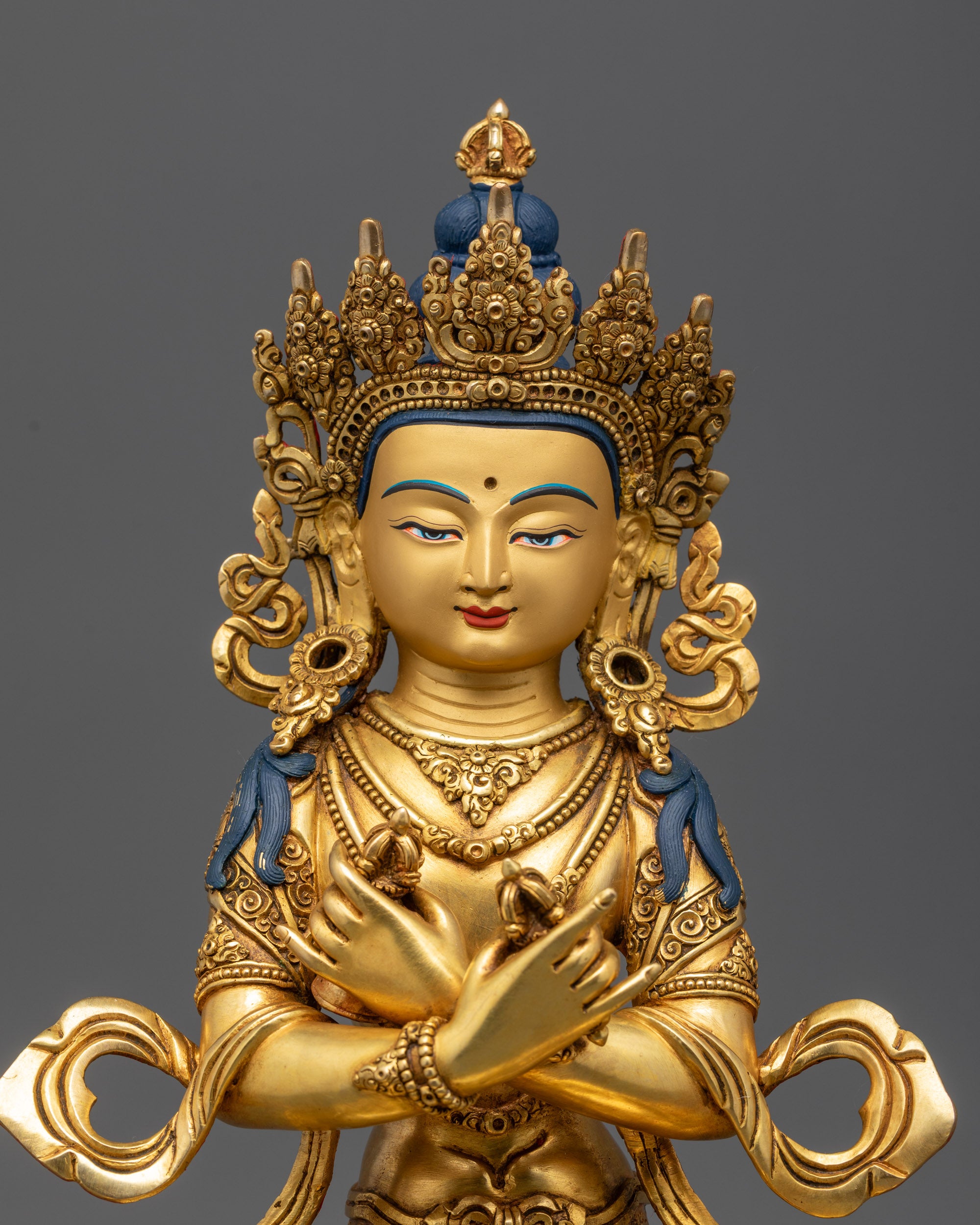 Close up of Vajradhara statue showing calm expression and intricate floating robe details