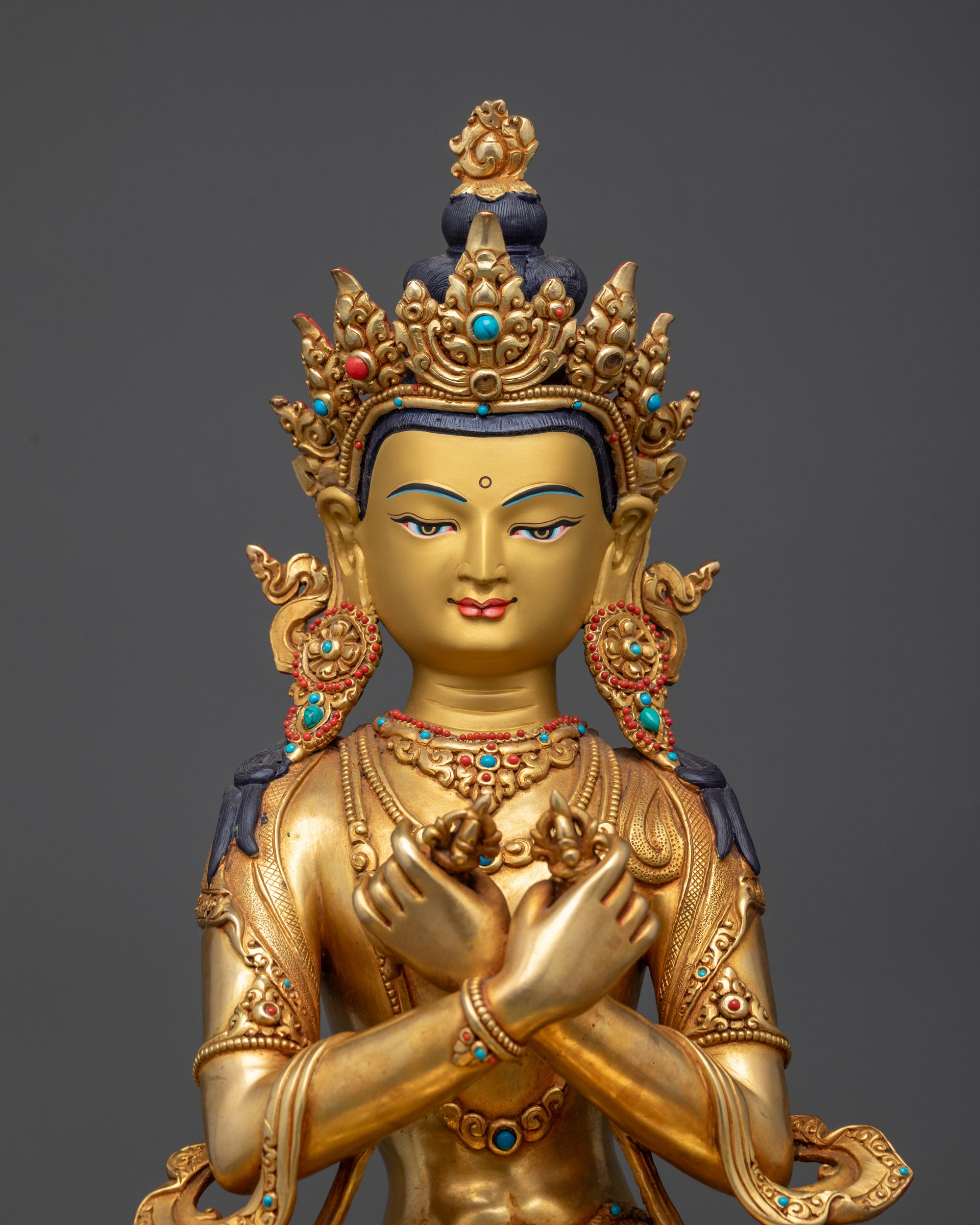 Close up of Vajradhara statue showing five-jeweled crown and semi-precious earrings