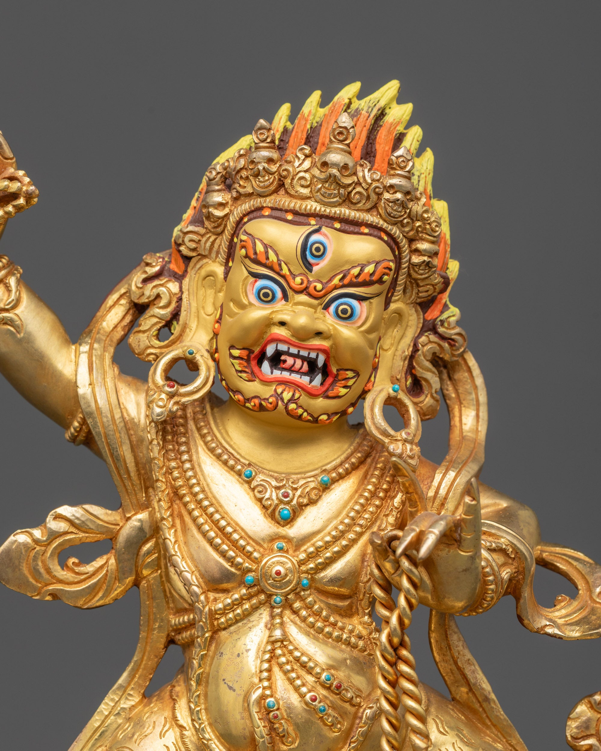 Close up of Vajrapani Sculpture showing wrathful face and dynamic dancing posture