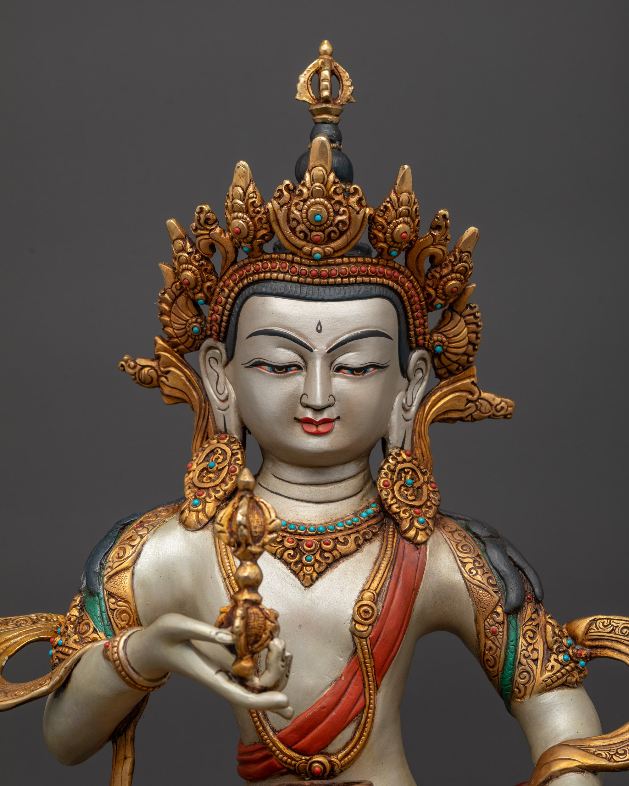 Close up of Vajrasattva holding vajra and bell on lotus seat