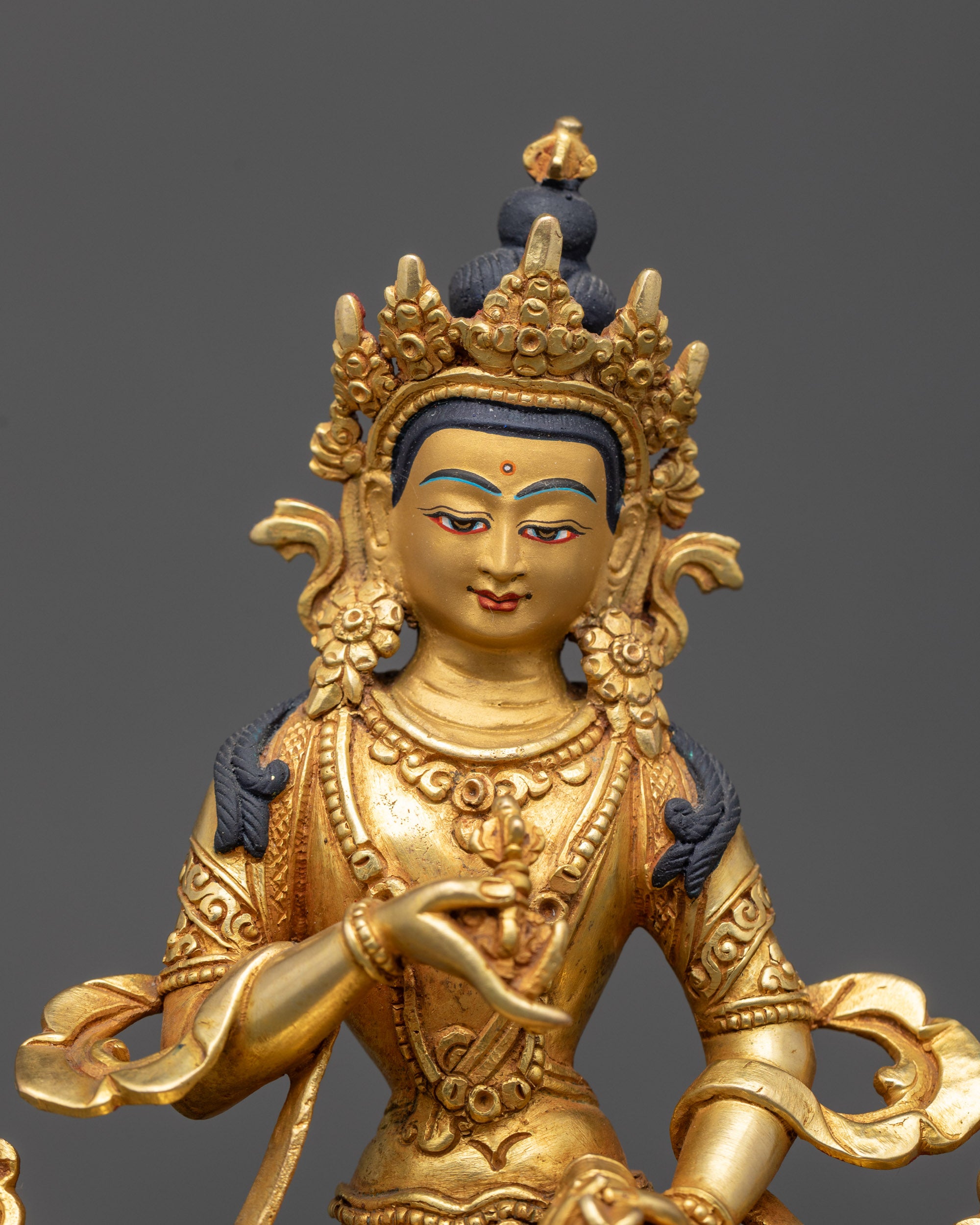 Close up of Vajrasattva holding vajra and bell, detailed gold fire-gilding and robes