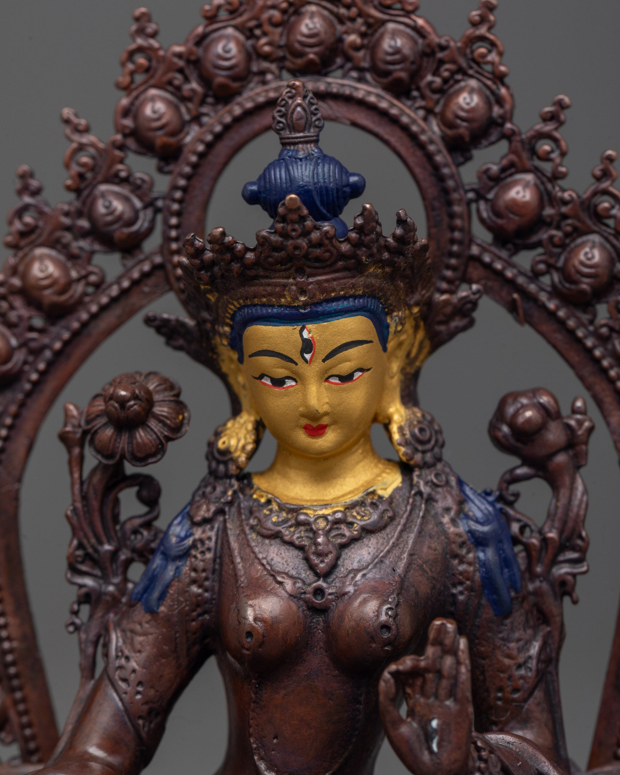 Close up of White Tara’s all-seeing seven eyes and delicate utpala flower details