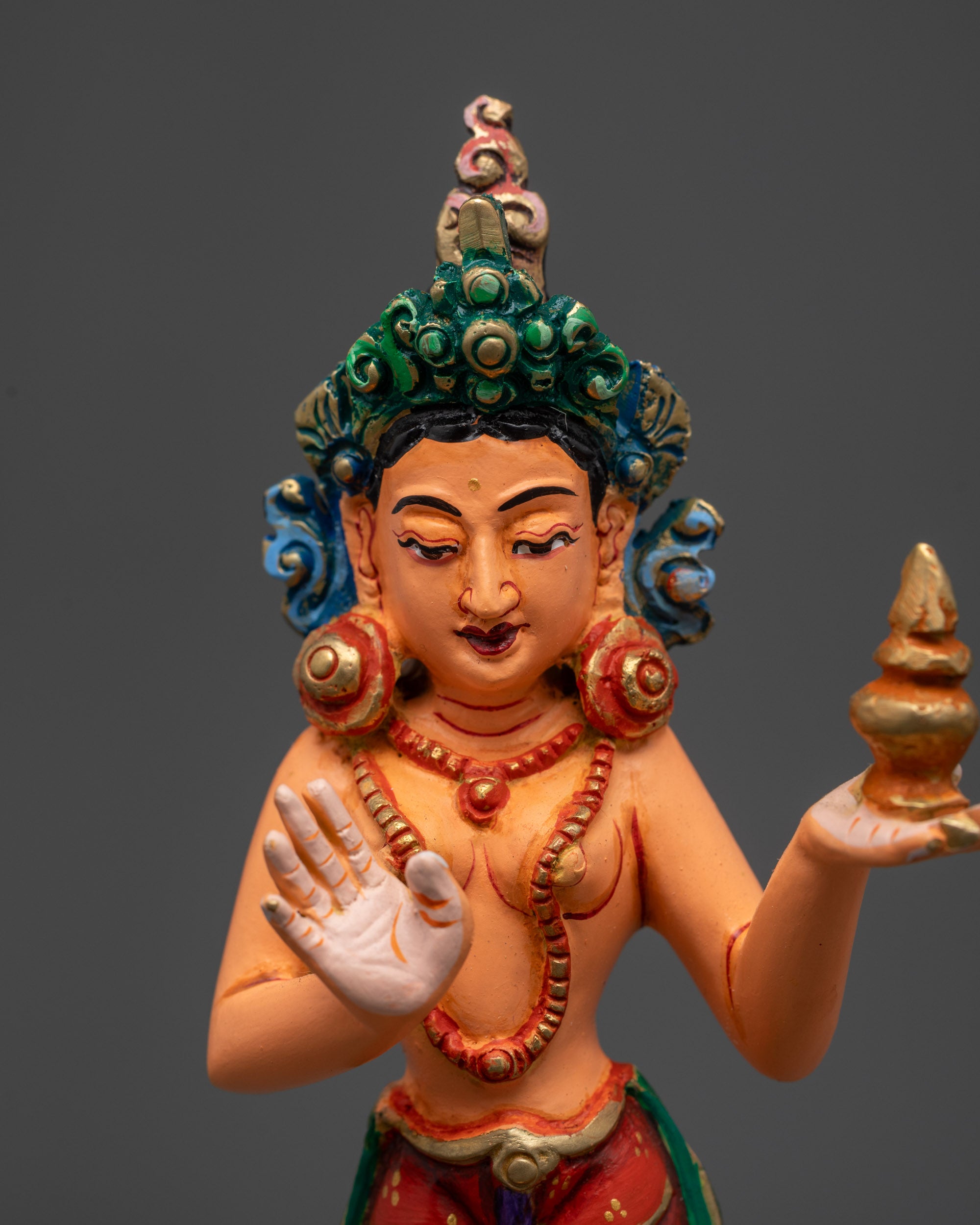 Close up of Yeshe Tsogyal disciple statue beside Guru Rinpoche on throne