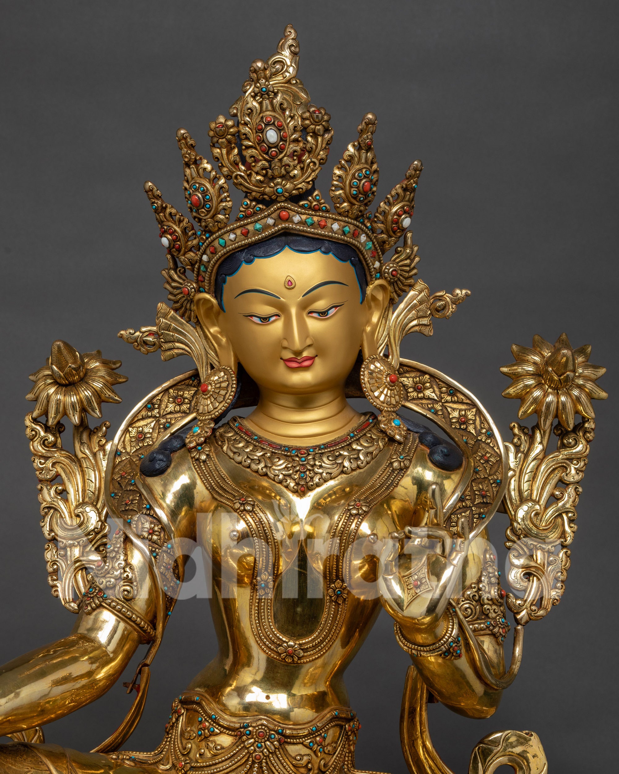 Close up of patterned robe on handcrafted Nepalese Green Tara sculpture