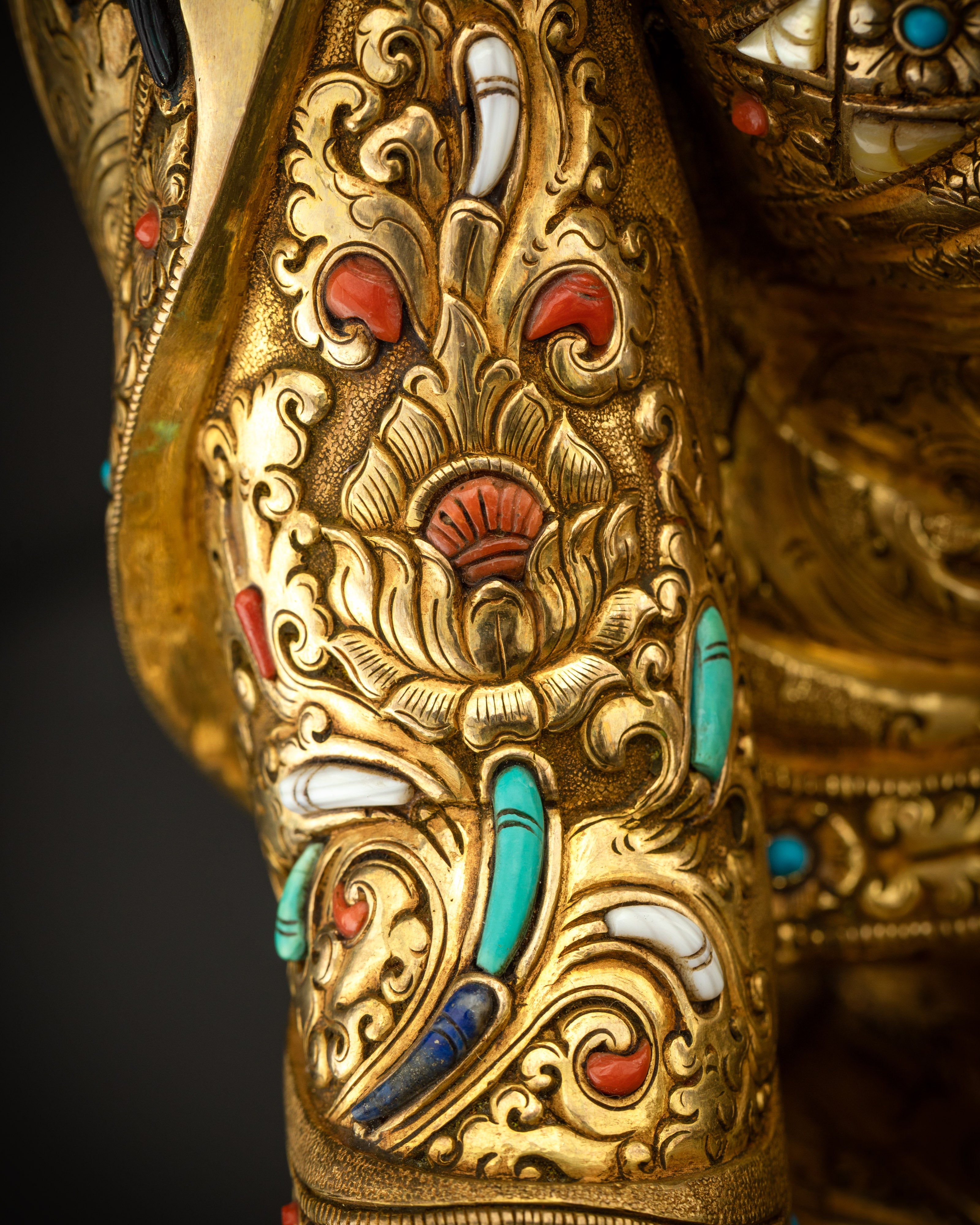 Close up of right side robe with detailed kasaya patterns and gilded finish