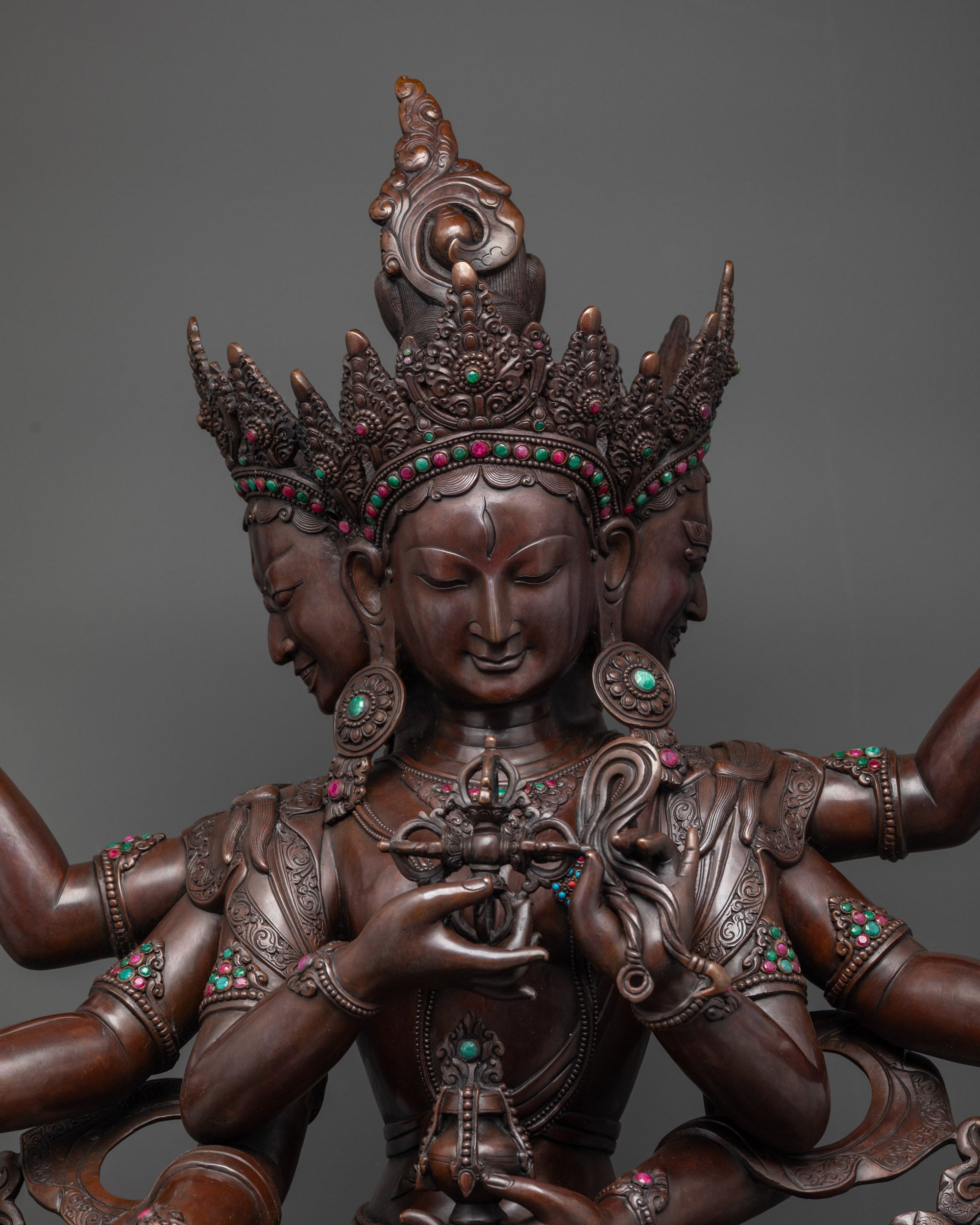 Close up oxidized Namgyalma face and crowns showing sacred symbols in copper