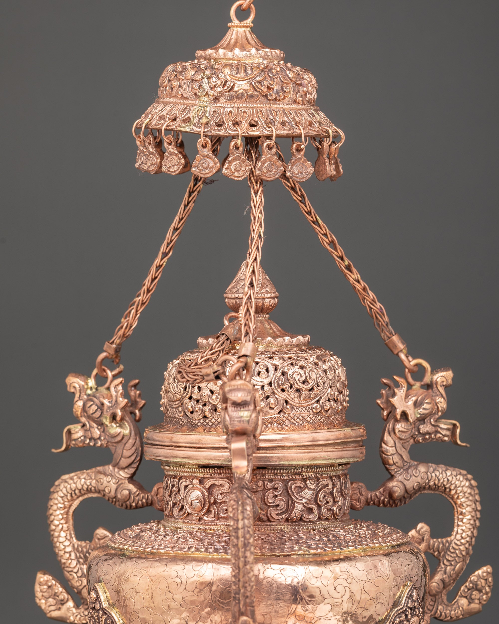 Close up perforated lid with parasol symbols on Tibetan Sangbur incense burner for Buddhist rituals